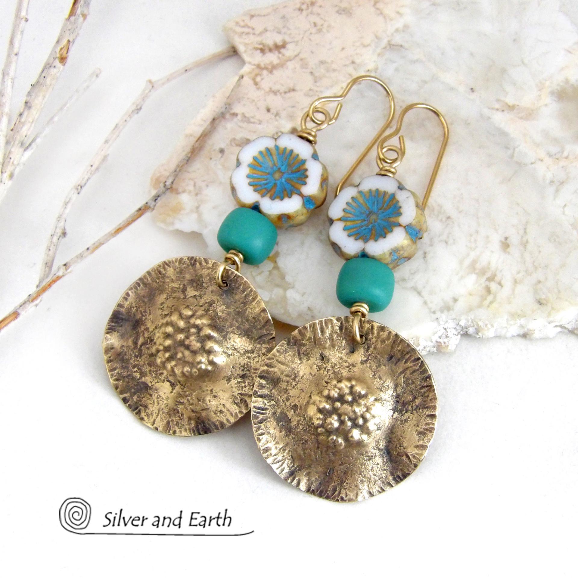 These earrings feature handcrafted gold brass dangles accented with beautifully detailed white and aqua blue Czech glass beads with gold highlights. Turquoise color glass beads were added for a pop of vibrant color. They have an earthy, modern boho feel that makes a striking statement. They'll make a great gift for a nature lover!