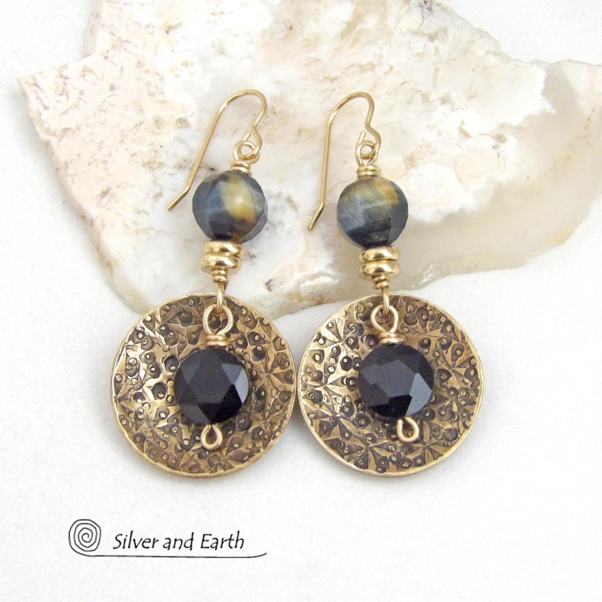These handcrafted earrings feature gold brass dangles with a hand stamped texture accented with black onyx and golden-black tiger's eye gemstones and tiny gold brass beads. The stones have a faceted cut which casts off a beautiful natural sparkle and shine. They have a modern, elegant boho chic style that looks great dressed up or down.
