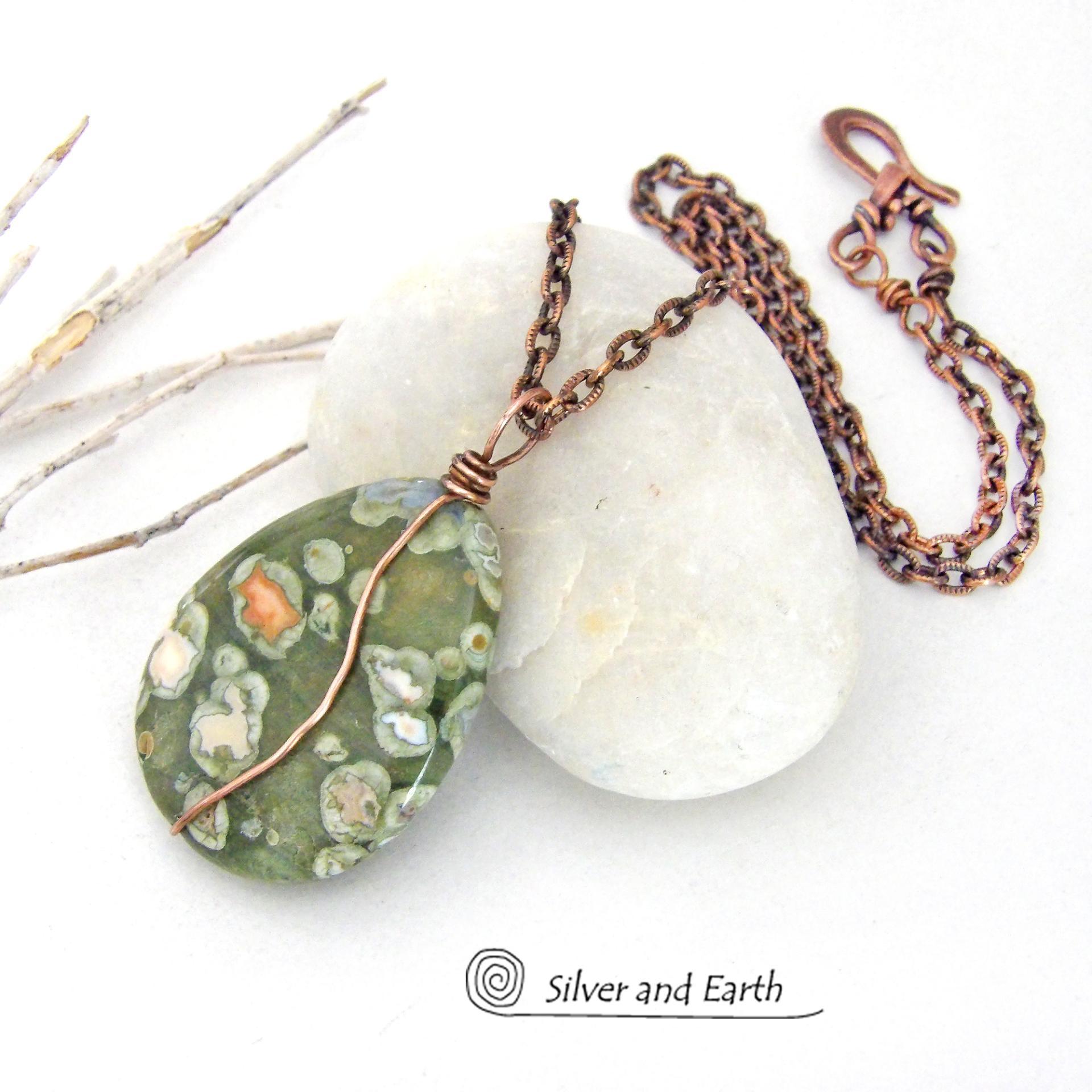 This pendant necklace is perfect for those that prefer a modern, simplistic and earthy style. It features a natural green rainforest jasper gemstone wrapped in copper wire on a textured and oxidized copper chain necklace. The stone has a beautiful natural matrix pattern in earthy hues of green with orbs of white inclusions and a touch of orange. 