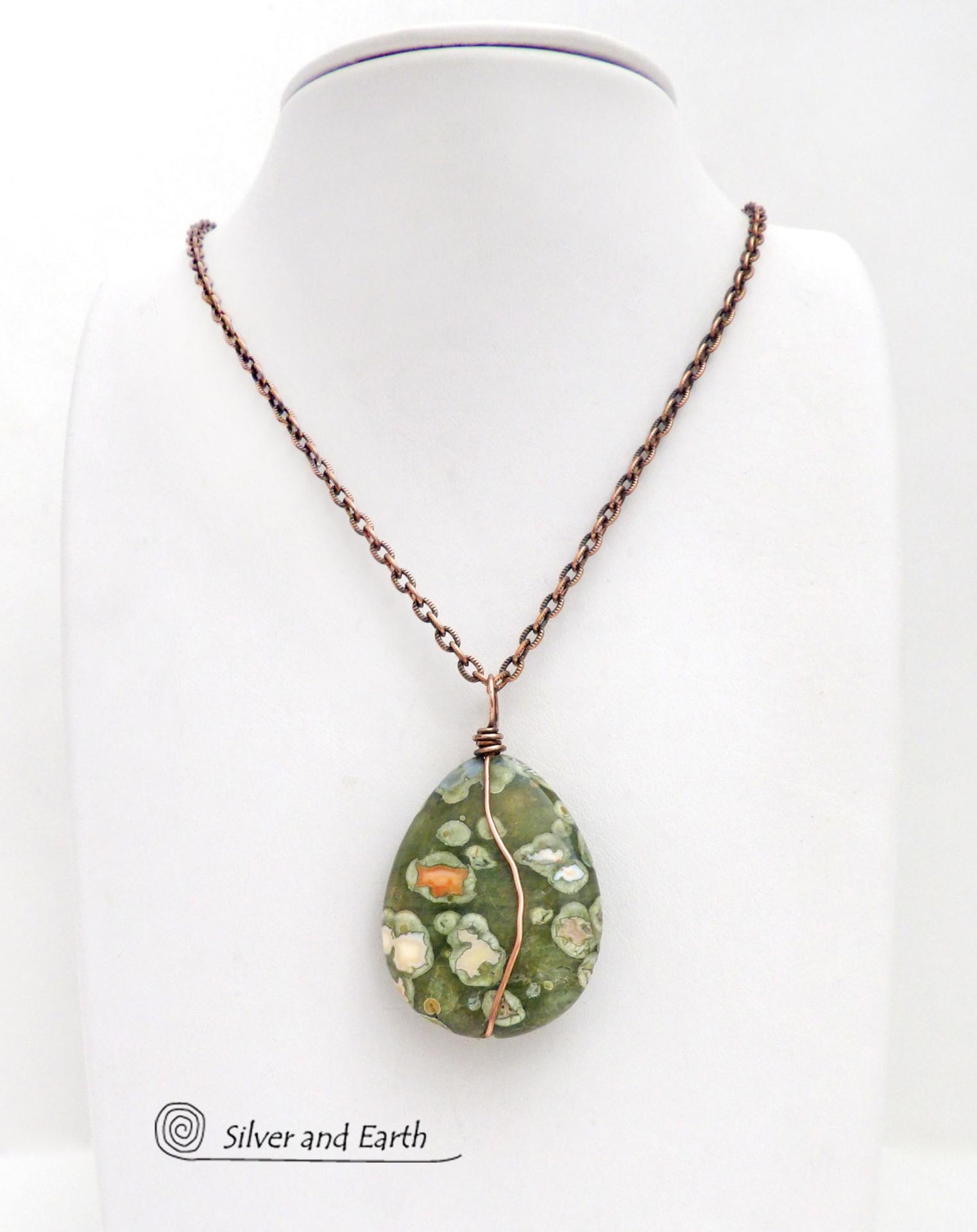 This pendant necklace is perfect for those that prefer a modern, simplistic and earthy style. It features a natural green rainforest jasper gemstone wrapped in copper wire on a textured and oxidized copper chain necklace. The stone has a beautiful natural matrix pattern in earthy hues of green with orbs of white inclusions and a touch of orange. 