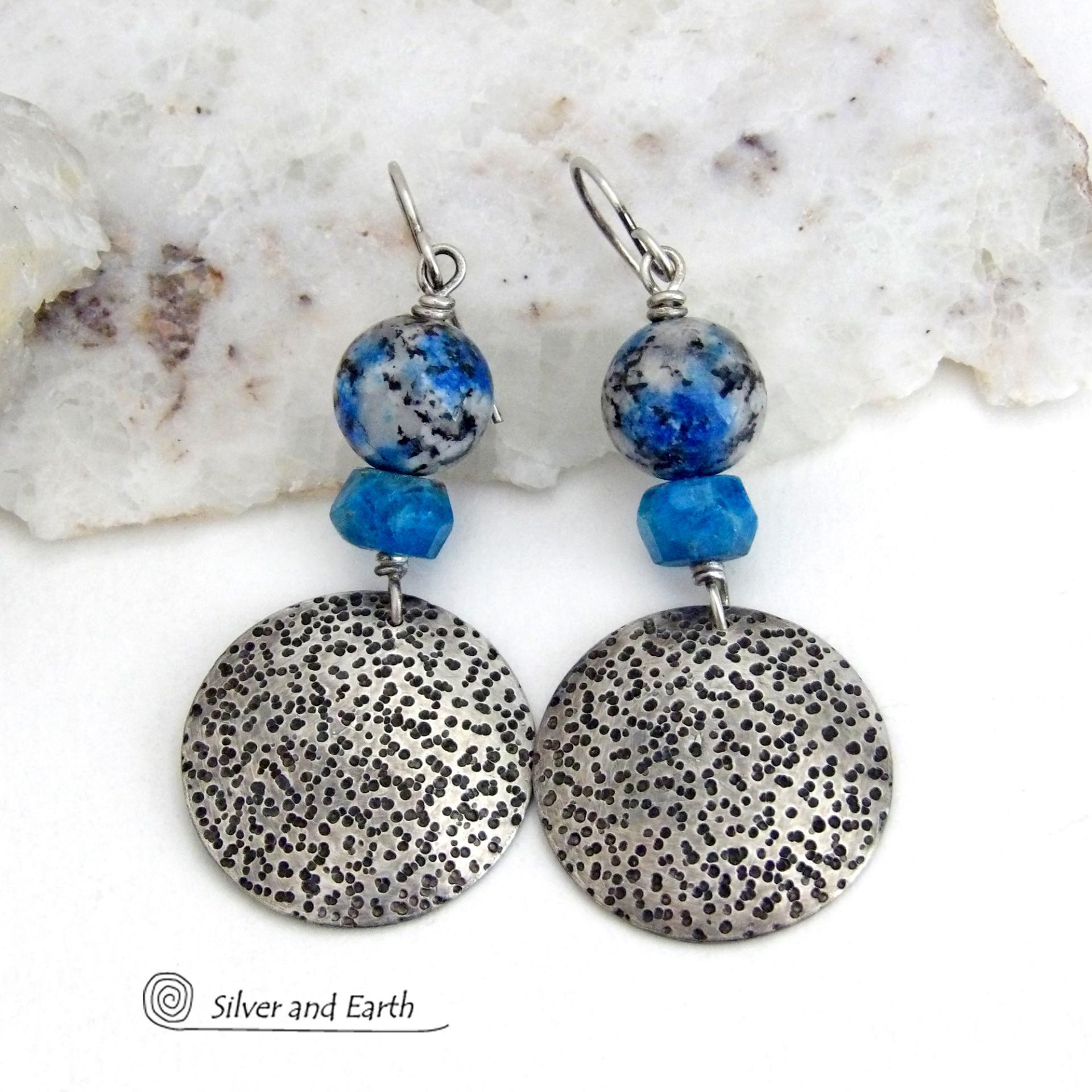 These handcrafted sterling silver earrings have a rustic, hand stamped texture and are accented with natural K2 granite and faceted blue apatite gemstones. This unique, interesting stone has beautiful blue azurite inclusions within a black and white speckled granite base. It was discovered in the foothills of world's second highest mountain, Mount K2, which it's name is derived from. The blue apatite was added to bring out the gorgeous blue inclusions in these stones. 