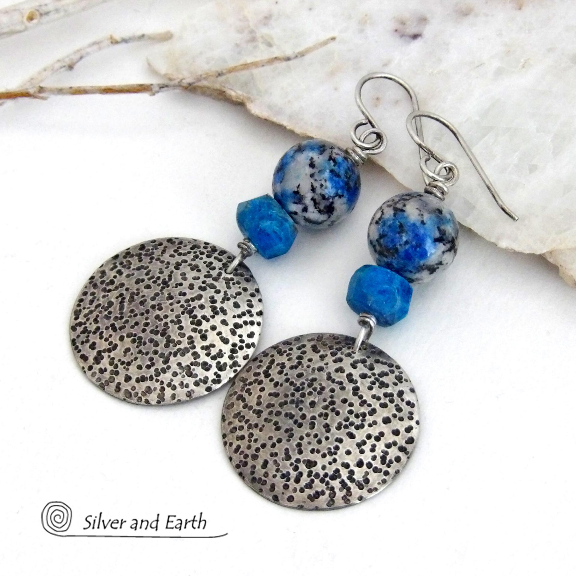 These handcrafted sterling silver earrings have a rustic, hand stamped texture and are accented with natural K2 granite and faceted blue apatite gemstones. This unique, interesting stone has beautiful blue azurite inclusions within a black and white speckled granite base. It was discovered in the foothills of world's second highest mountain, Mount K2, which it's name is derived from. The blue apatite was added to bring out the gorgeous blue inclusions in these stones. 