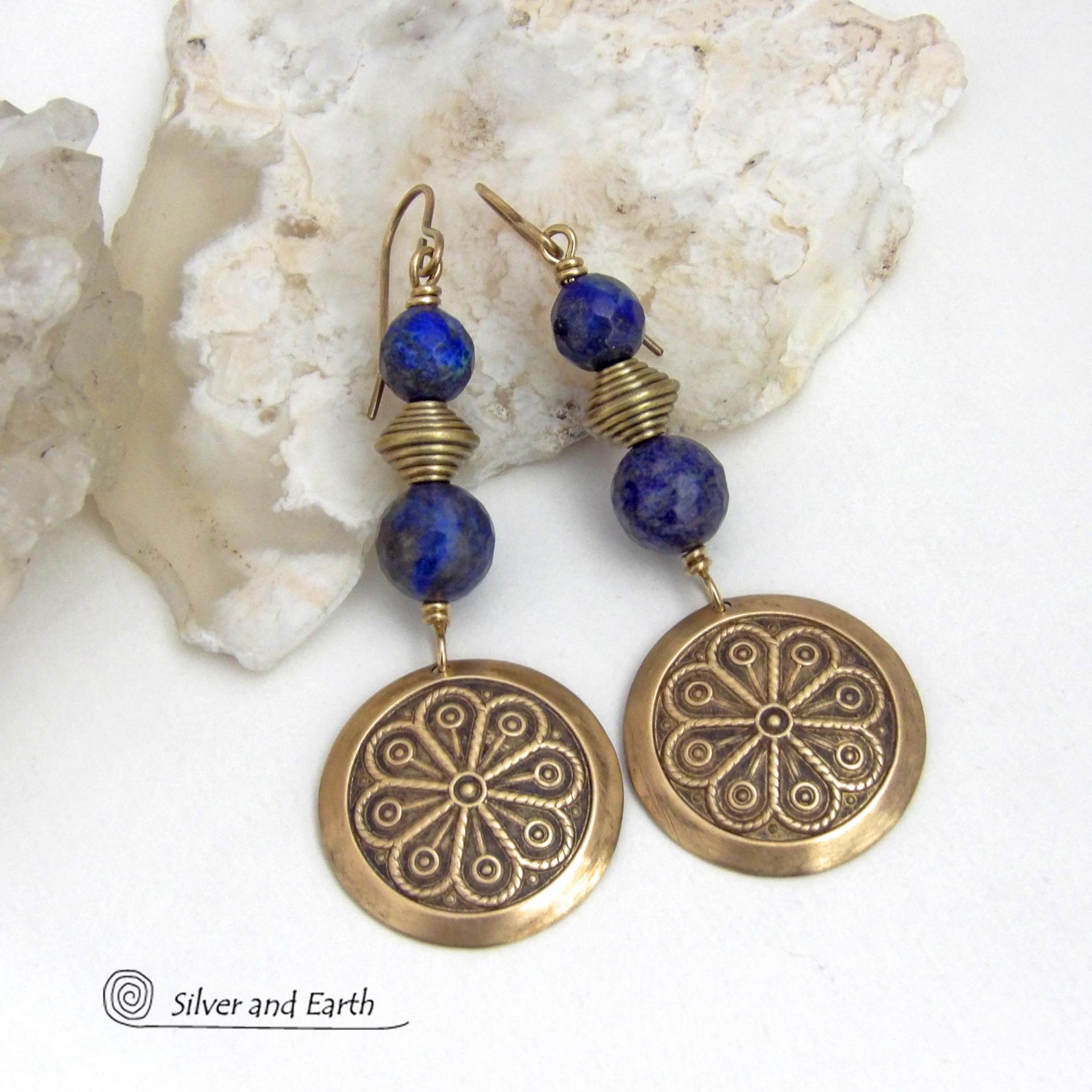 These handcrafted gold brass earrings have an exotic, Egyptian inspired vibe. They feature brass circle dangles with a beautiful embossed texture accented with faceted genuine lapis lazuli gemstones and textured brass beads. Bold and unique, they'll add a touch of cultural exotic charm to any type of wardrobe - dressed up or down. Perfect for women that love unique artisan handcrafted jewelry. Handmade in the USA by Silver and Earth Jewelry. 