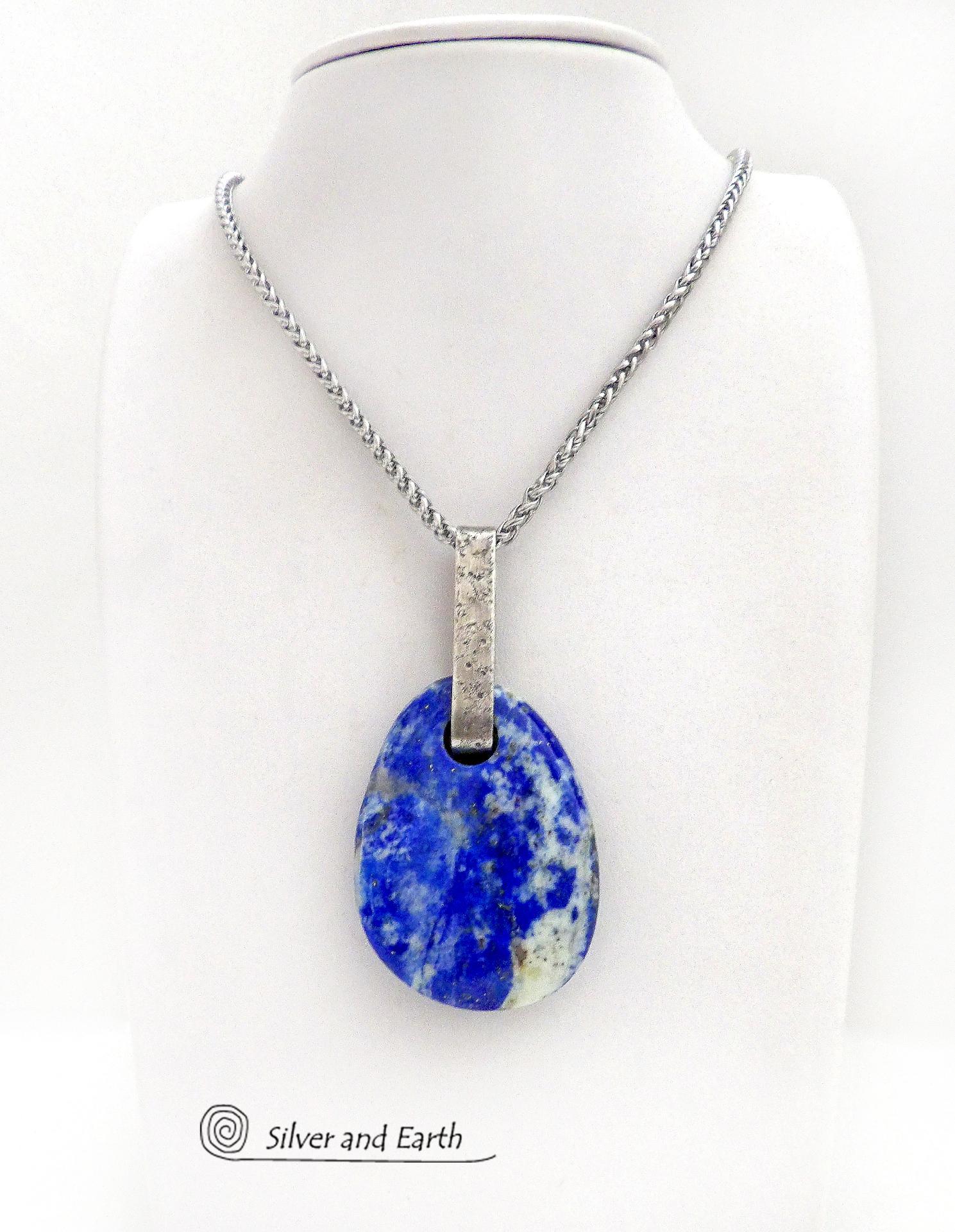 This one-of-a-kind necklace features a gorgeous, natural lapis lazuli gemstone accented with a handcrafted sterling silver bail with a lightly hammered organic texture. The stone is a beautiful shade of blue with white inclusions, along with a sprinkling of natural sparkly pyrite inclusions. The stone is equally gorgeous on both sides, so I designed it to be reversible. (See all photos for alternate sides). Makes a great gift for a natural stone lover - or a nice addition to your own jewelry wardrobe.
