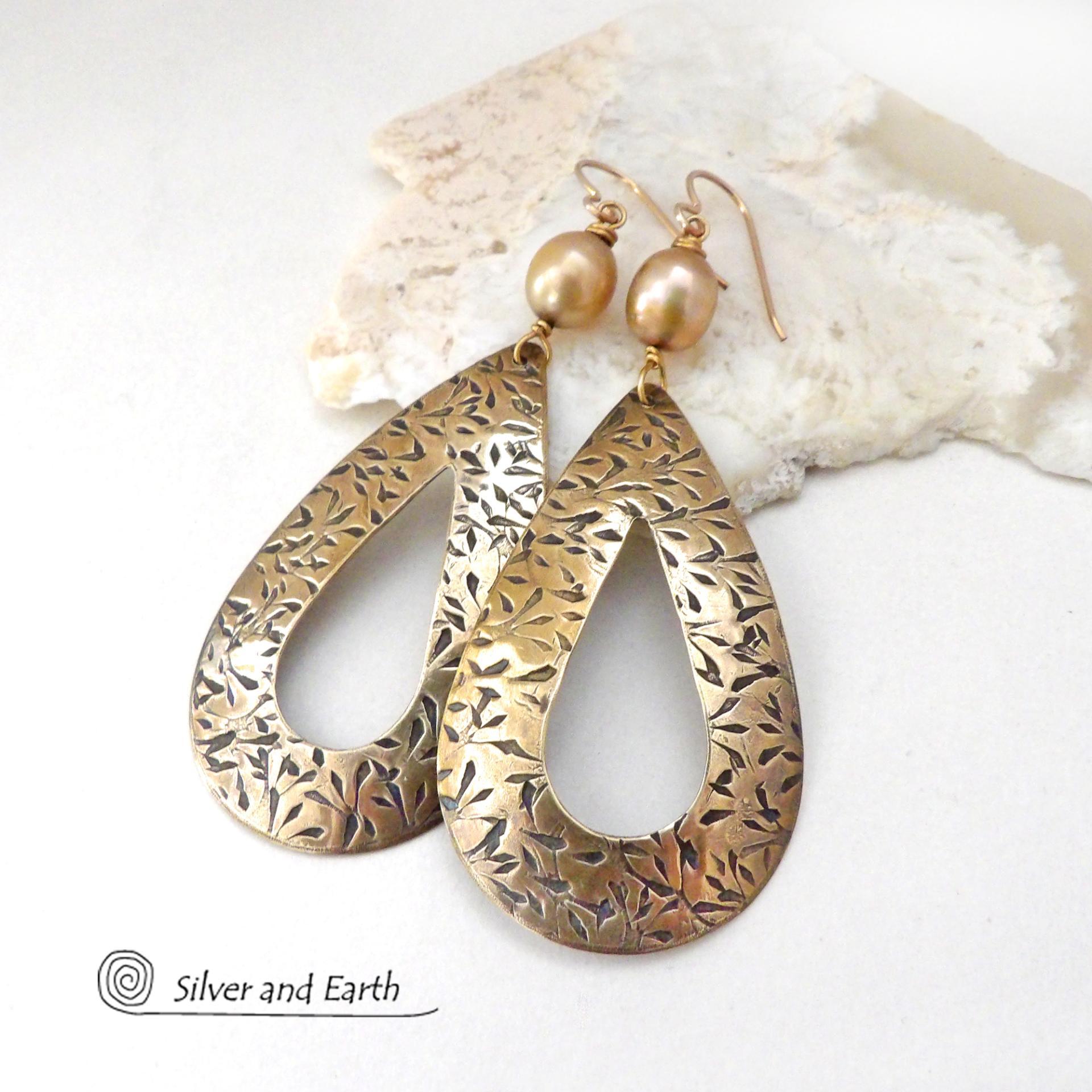 These gold brass hoop earrings have an intricate hand stamped texture and are accented with gold freshwater pearls. Big and bold, these earrings are a real statement piece and would be perfect for any occasion. 