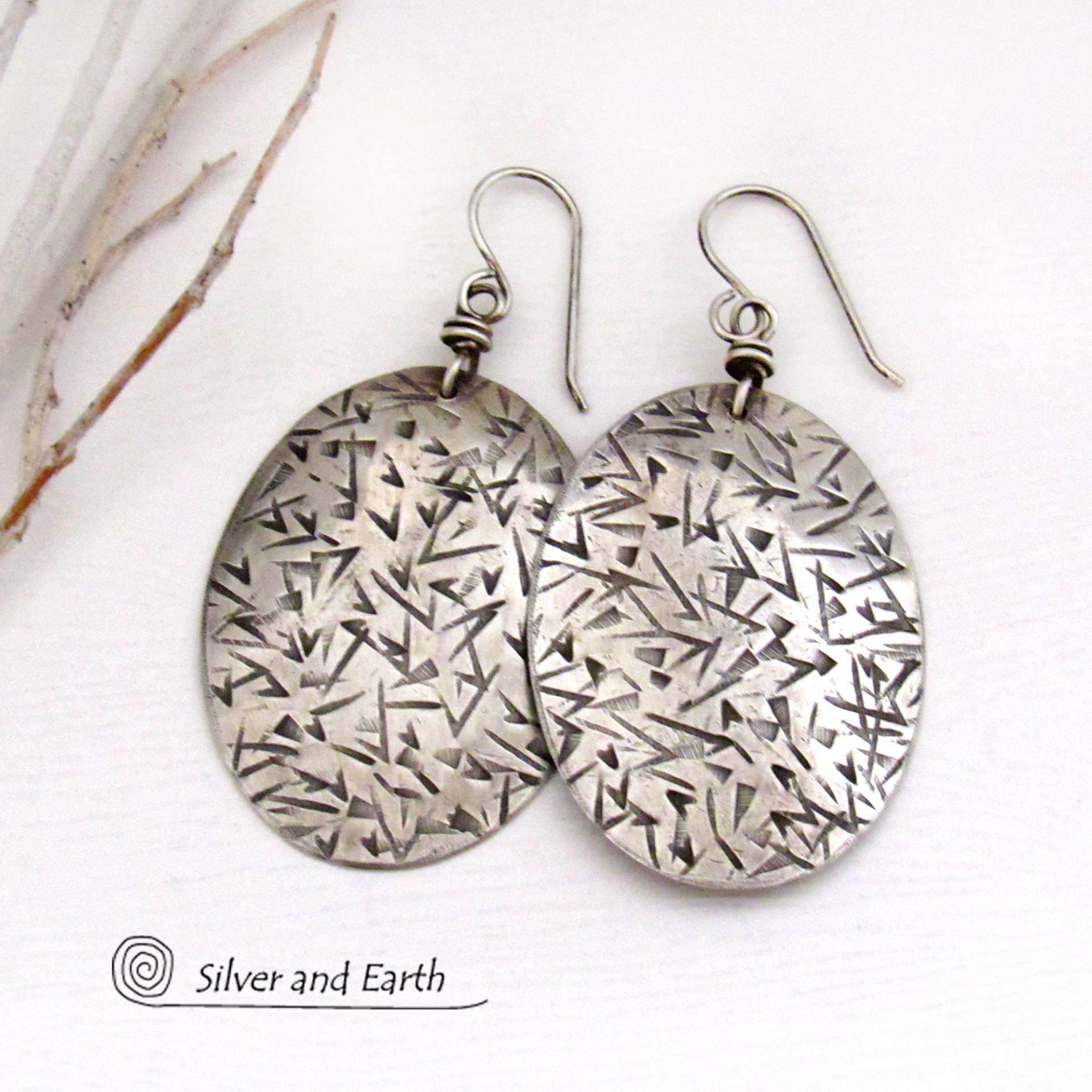 These large sterling silver dangle earrings have a modern, contemporary feel. Perfect "go to" earrings that can be worn everyday with all wardrobe types.