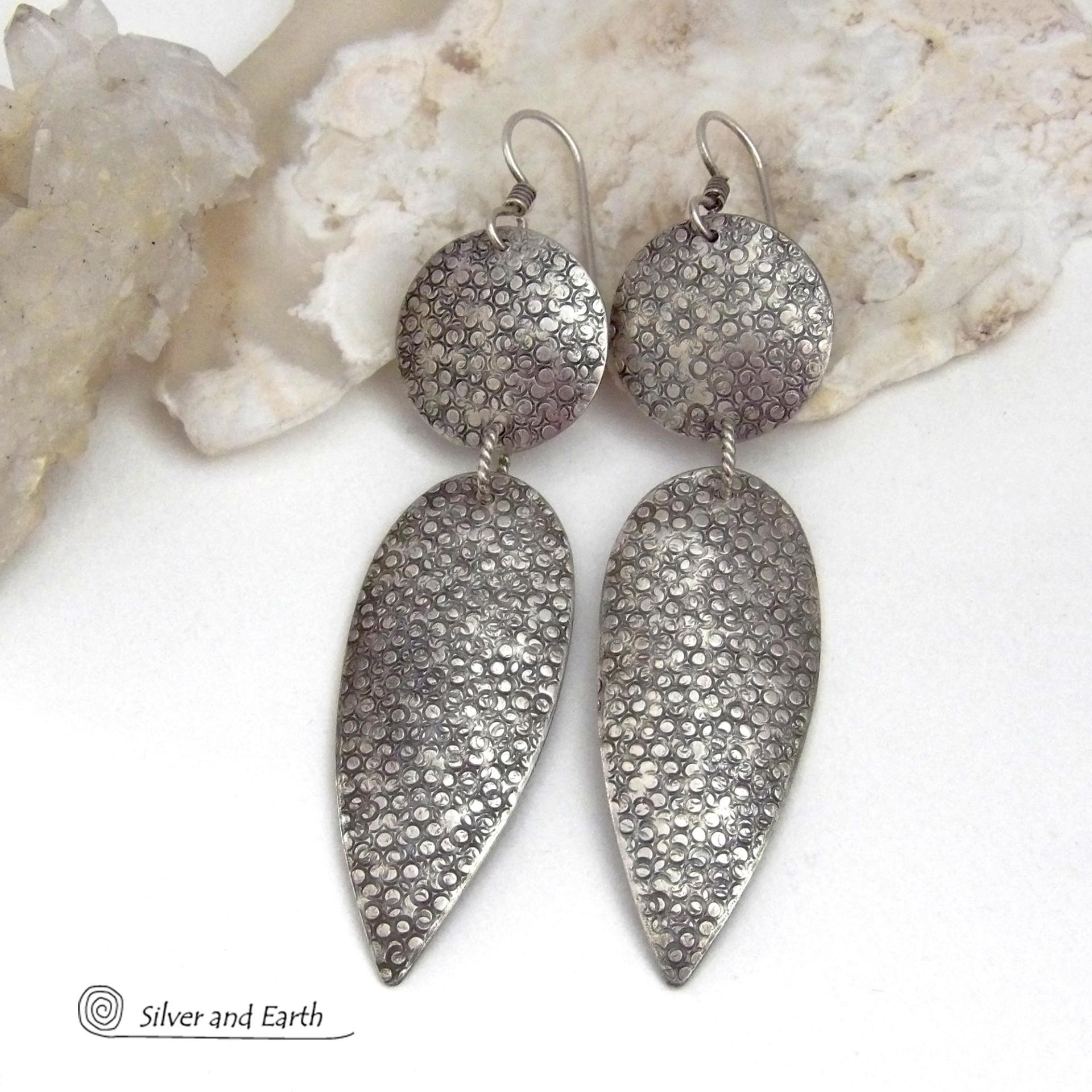 Bold, modern and contemporary - these long handcrafted sterling silver earrings feature an intricate hand textured design. They have an urban chic appeal and will look great with all wardrobe styles. They go with everything! Earrings are sturdy & substantial - yet lightweight and comfortable for all day wear.   MEASUREMENTS: Total length: 3" from top of sterling silver ear wires and 3/4” at widest point. Handmade in the USA by Silver and Earth Jewelry. 