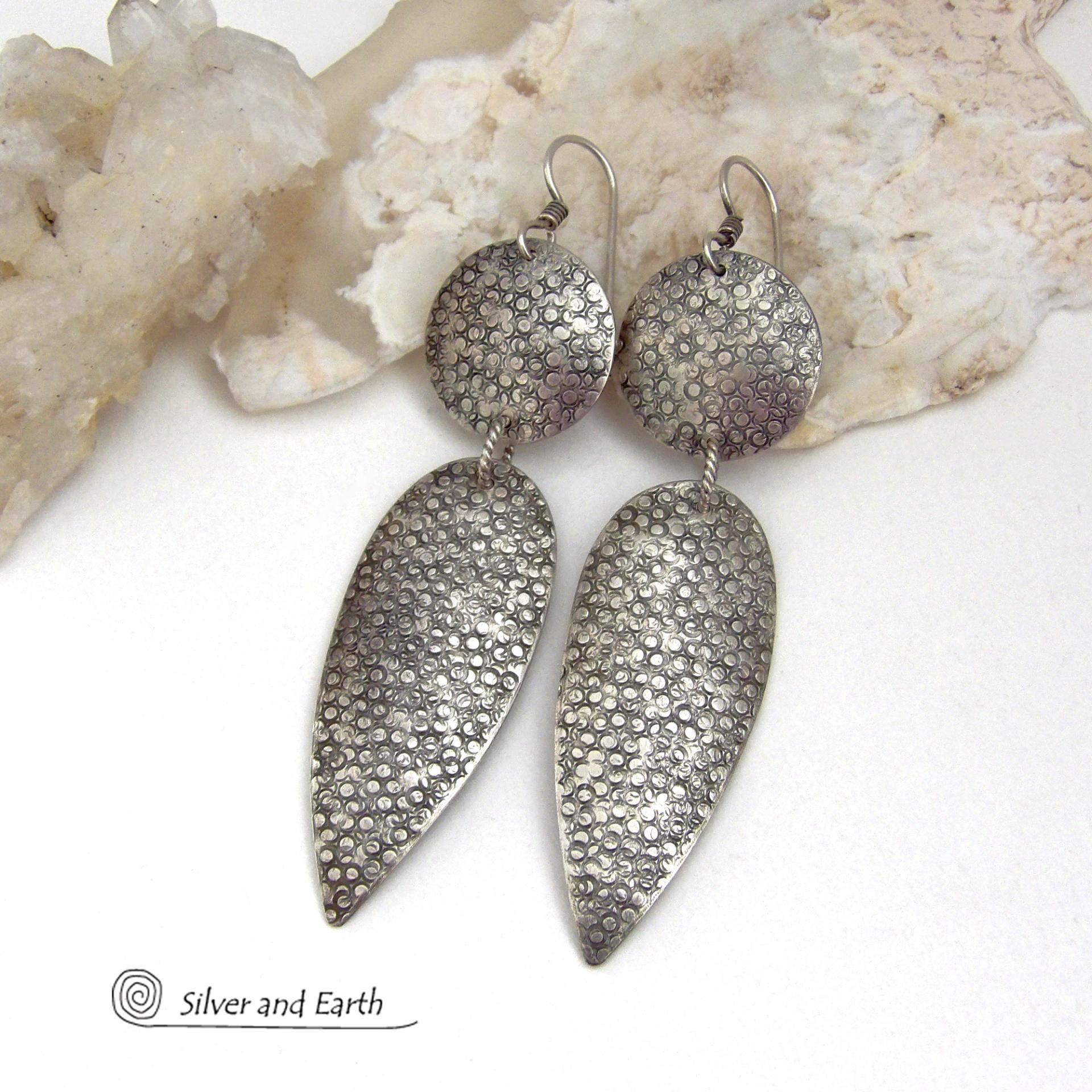 Bold, modern and contemporary - these long handcrafted sterling silver earrings feature an intricate hand textured design. They have an urban chic appeal and will look great with all wardrobe styles. They go with everything! Earrings are sturdy & substantial - yet lightweight and comfortable for all day wear.   MEASUREMENTS: Total length: 3" from top of sterling silver ear wires and 3/4” at widest point. Handmade in the USA by Silver and Earth Jewelry. 