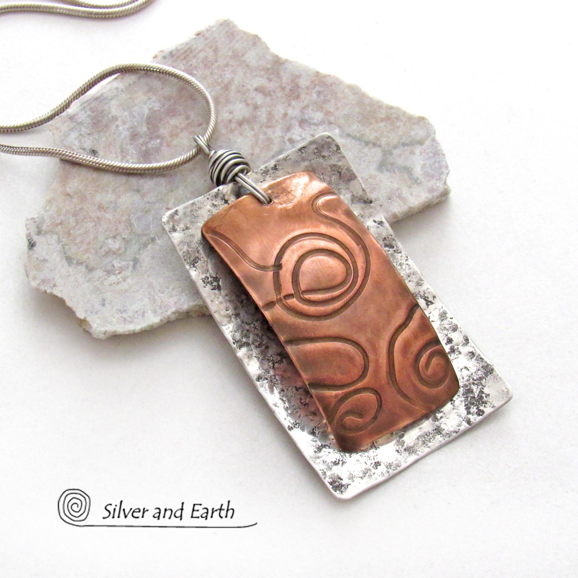 This unique mixed metal necklace has a contemporary, modern design. It features uniquely textured copper framed against a background of lightly hammered sterling silver. The combination of metals can easily mix and match with other copper and silver accessories in your wardrobe. Bold and striking, it's a one of a kind piece!