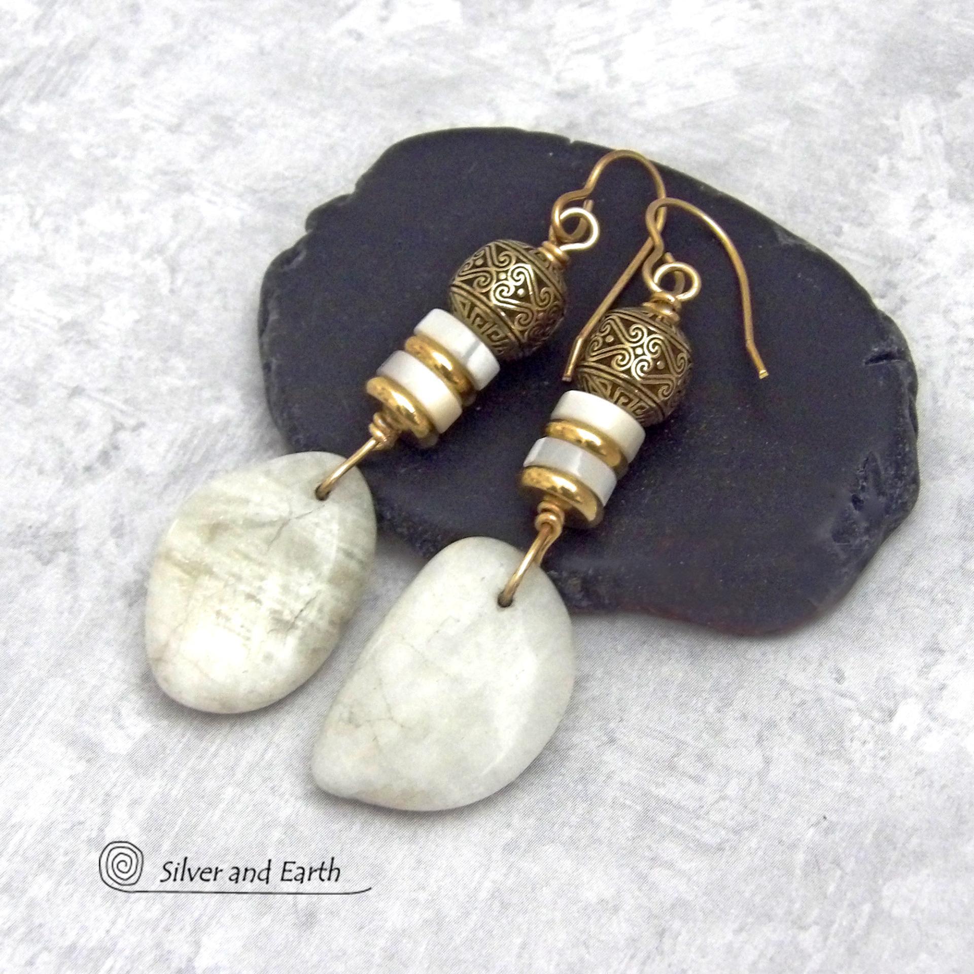 These earrings feature natural white moonstone nuggets accented with white Mother of Pearl and brass beads. They are topped off with larger brass beads that have an intricate filigree design. They have a modern chic style with a touch of exotic flair that looks great with all wardrobe types. They'll make a great gift for a natural stone lover - or a nice addition to your own jewelry collection.