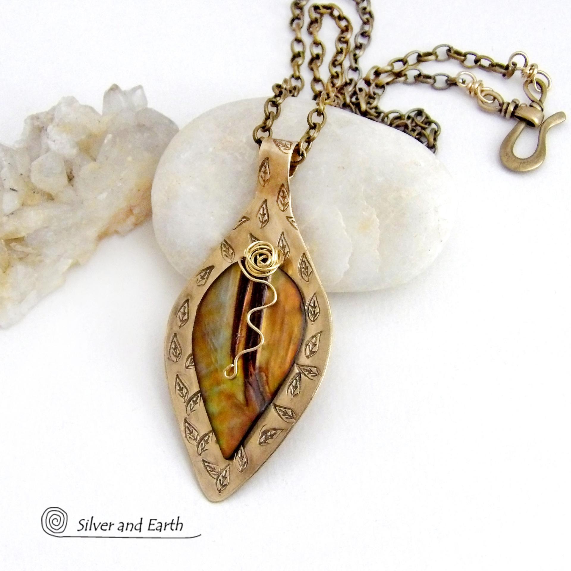 This necklace features a golden brown carved Mother of Pearl leaf accented against a handcrafted gold brass base. I hand sawed the base out of solid gold brass sheet and stamped the metal with a leaf pattern to "echo" the Mother of Pearl leaf. Unique and one-of-kind, it'll make a great gift for a nature lover - or a nice addition to your own jewelry wardrobe. It comes on an 18" antiqued brass chain with lobster claw closure. Handmade in the USA by Silver and Earth Jewelry. 