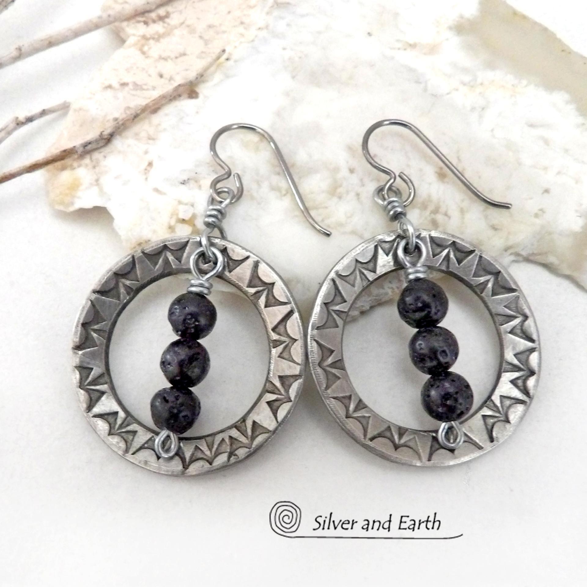 These handcrafted silver pewter hoop earrings have a hand stamped texture accented with black lava rock stones dangling in front. The stones have natural "pits" and crevices which is expected with porous lava stones. Lava stone is formed when molten rock erupts from an active volcano and comes in contact with the cool atmosphere of the Earth, which begins to solidify it. They have an earthy chic style that coordinates with all wardrobe types.