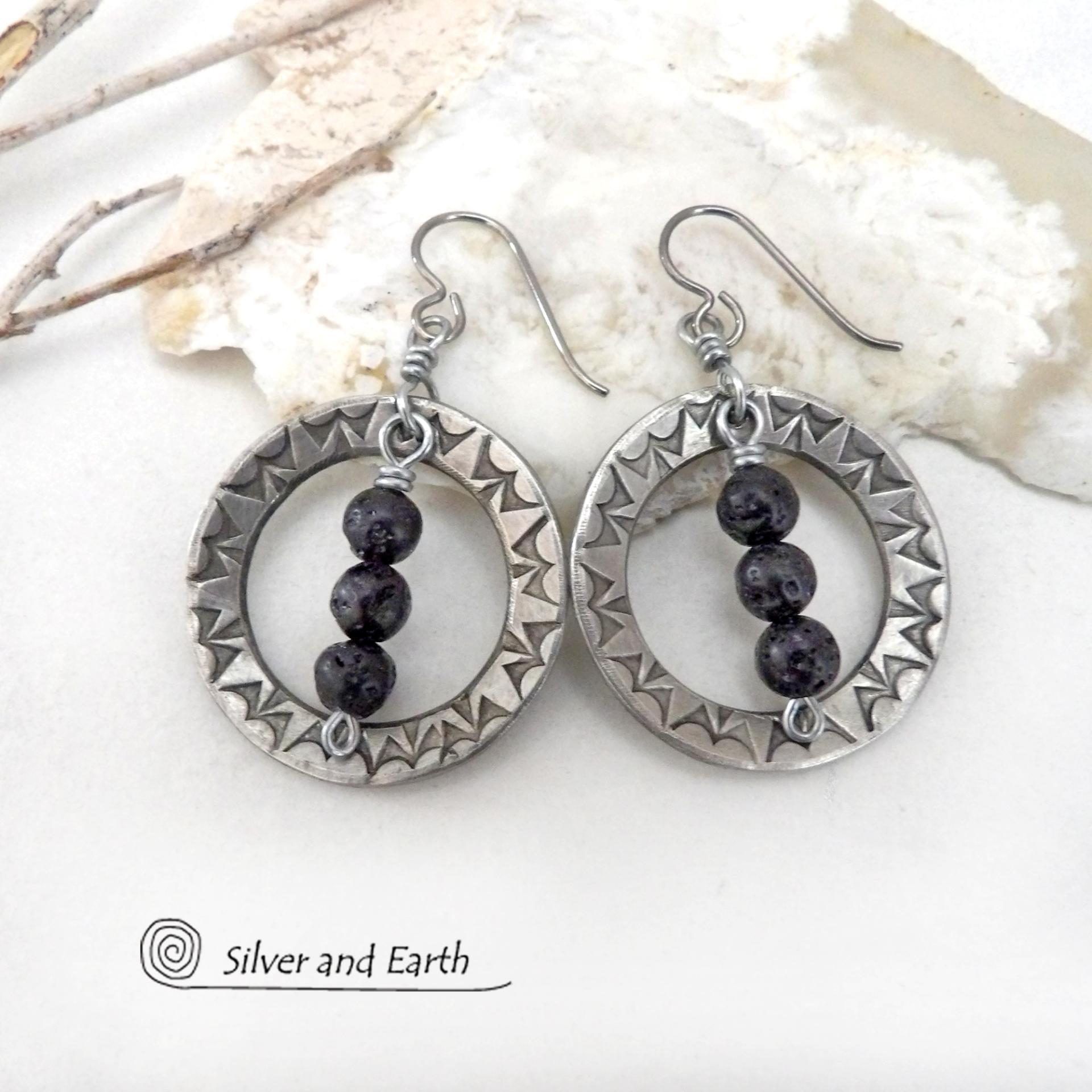 These handcrafted silver pewter hoop earrings have a hand stamped texture accented with black lava rock stones dangling in front. The stones have natural "pits" and crevices which is expected with porous lava stones. Lava stone is formed when molten rock erupts from an active volcano and comes in contact with the cool atmosphere of the Earth, which begins to solidify it. They have an earthy chic style that coordinates with all wardrobe types.