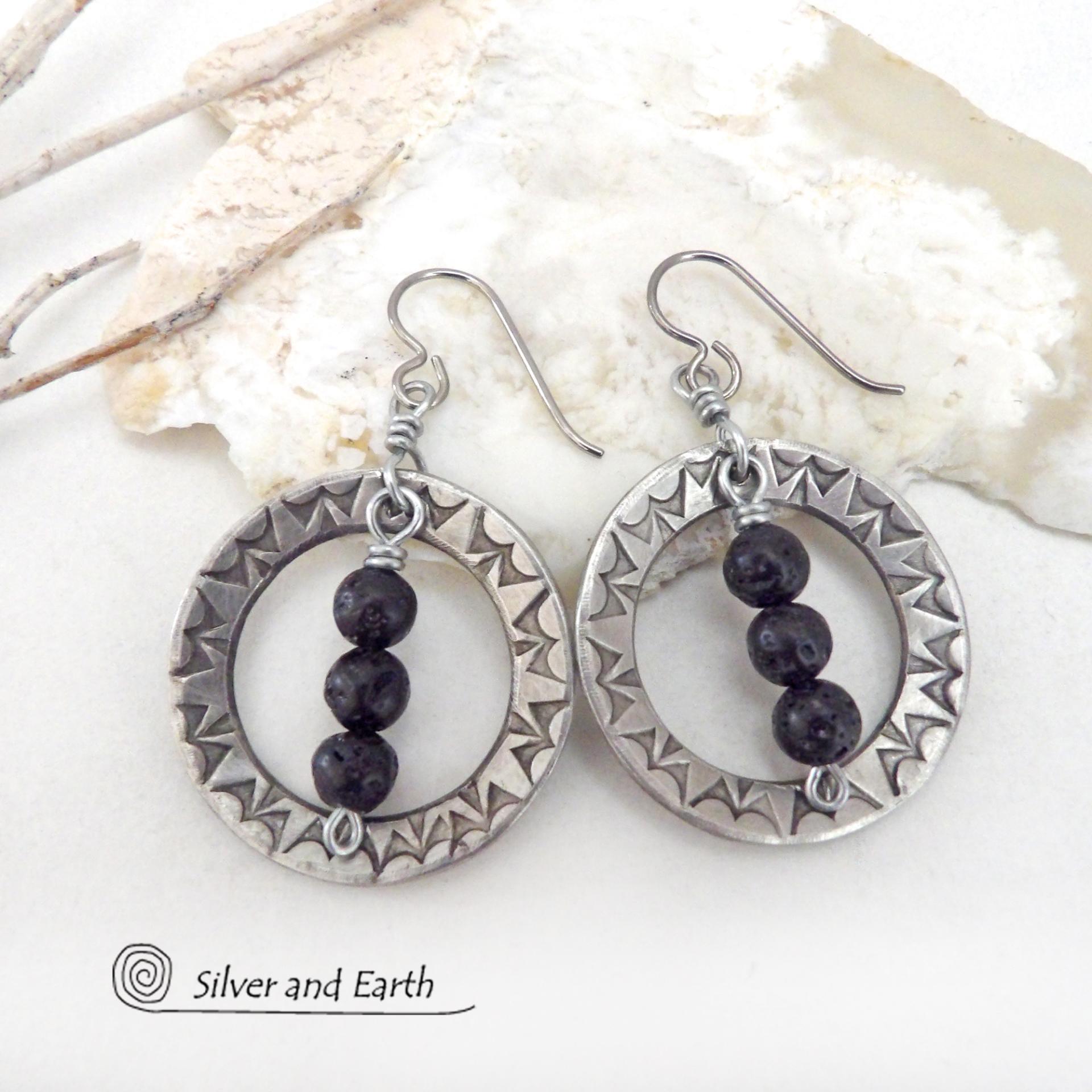 These handcrafted silver pewter hoop earrings have a hand stamped texture accented with black lava rock stones dangling in front. The stones have natural "pits" and crevices which is expected with porous lava stones. Lava stone is formed when molten rock erupts from an active volcano and comes in contact with the cool atmosphere of the Earth, which begins to solidify it. They have an earthy chic style that coordinates with all wardrobe types.