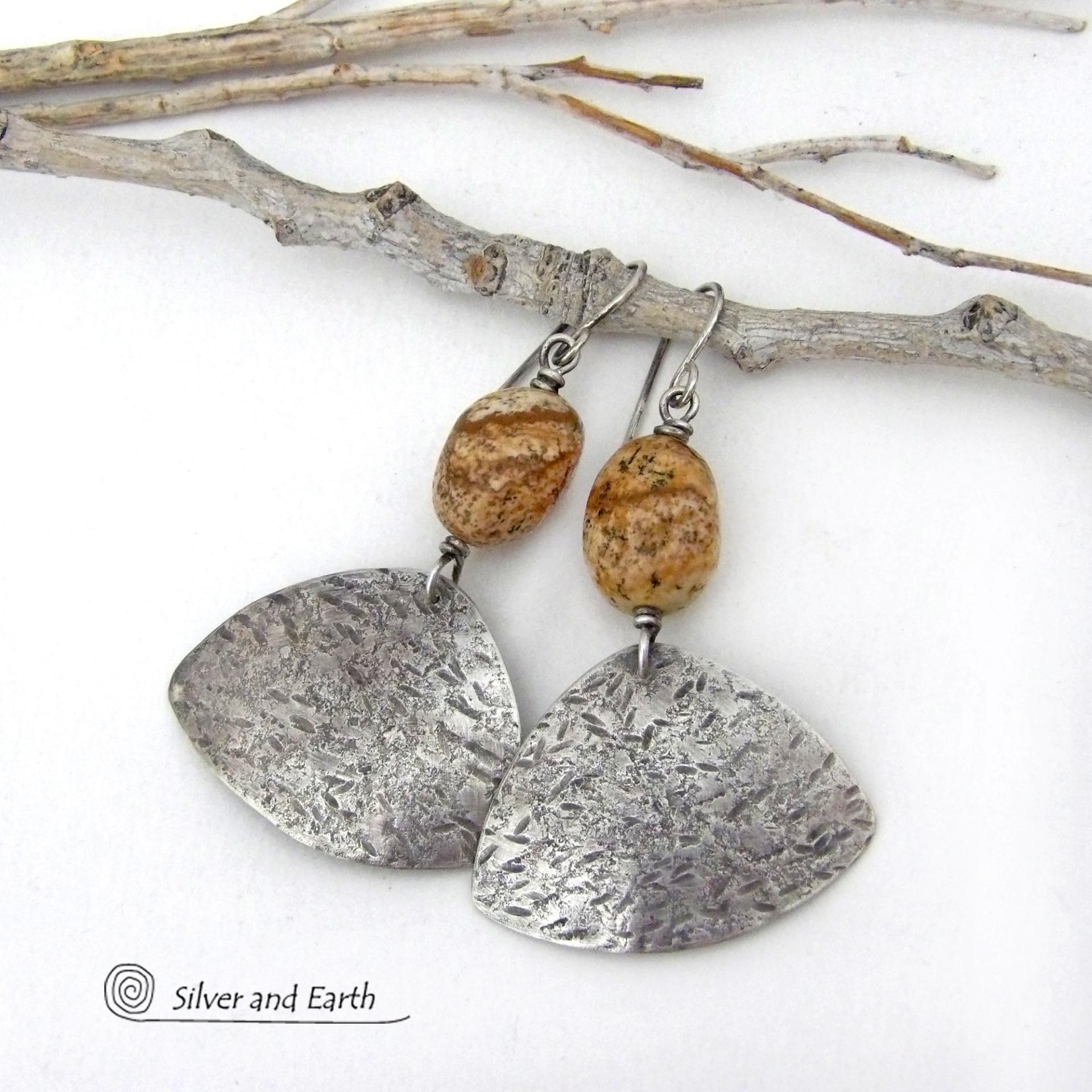 These handcrafted earrings feature natural picture jasper stones accented with textured sterling silver dangles. They have a modern, earthy design that looks great with all wardrobe styles. The stones have a natural pattern of brown streaks and black speckles against a tan background. I created the dangles out of solid sterling silver sheet; hammered them for an earth, organic texture; then oxidized them to enhance the detail. Earrings have a coordinating necklace sold separately. 