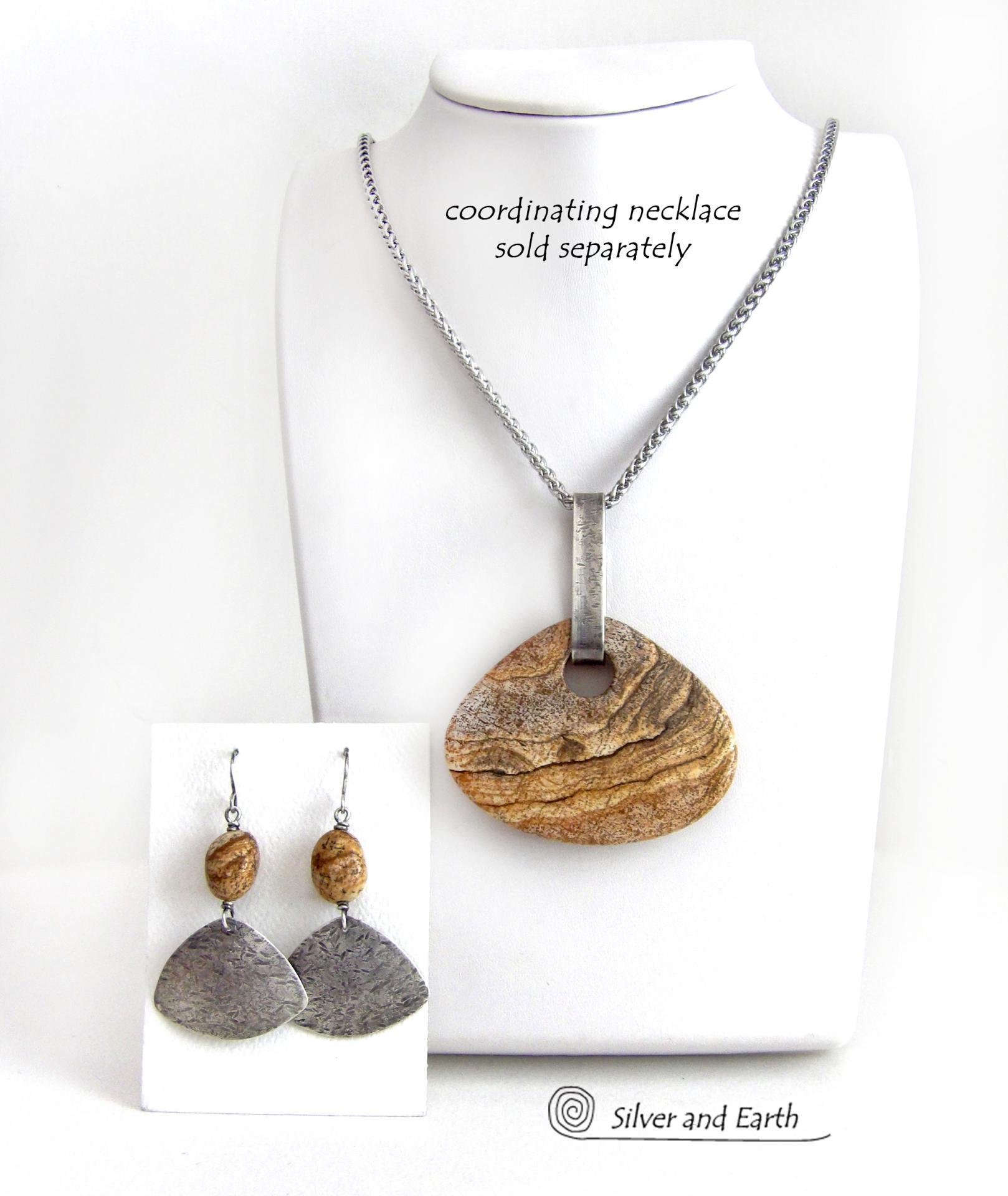 These handcrafted earrings feature natural picture jasper stones accented with textured sterling silver dangles. They have a modern, earthy design that looks great with all wardrobe styles. The stones have a natural pattern of brown streaks and black speckles against a tan background. I created the dangles out of solid sterling silver sheet; hammered them for an earth, organic texture; then oxidized them to enhance the detail. Earrings have a coordinating necklace sold separately. 