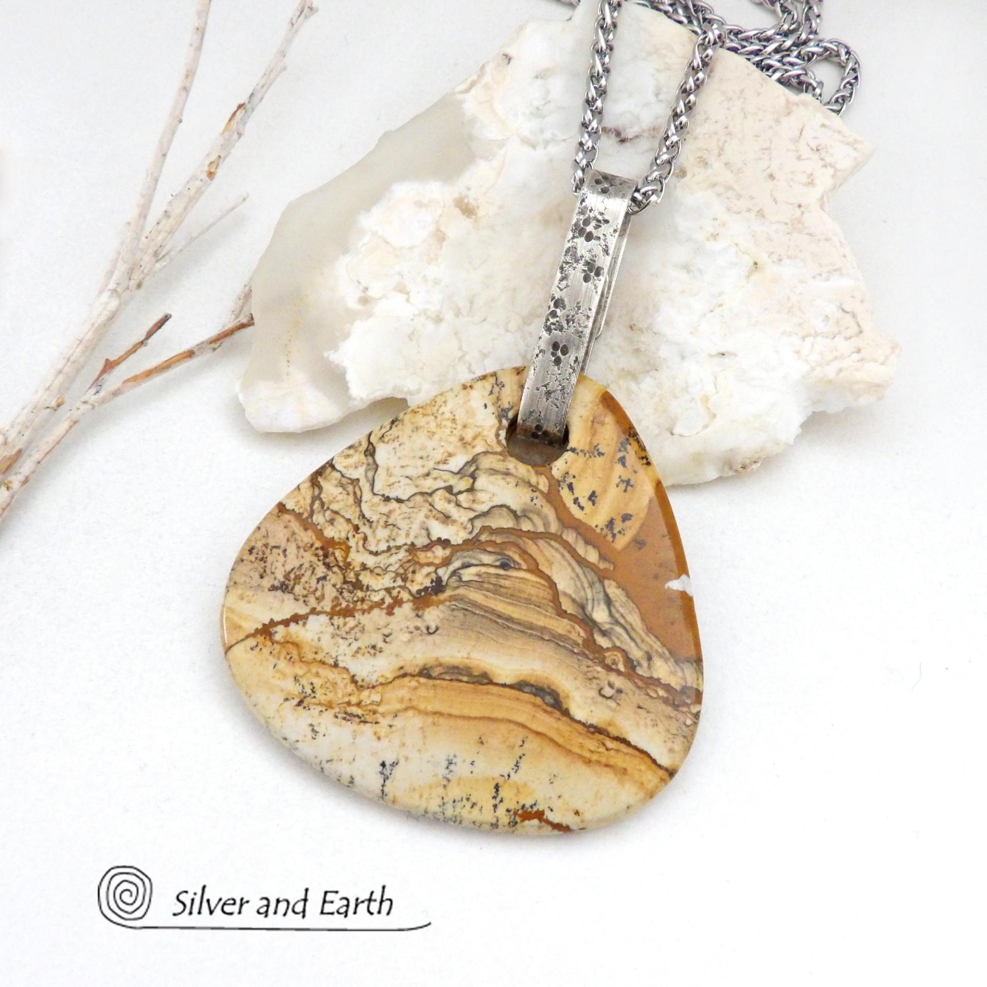 This one-of-a-kind necklace features a large stunning picture jasper stone accented with a handcrafted sterling silver bail. The stone has a beautiful natural pattern in various shades of brown, beige and gray. Big and bold, this necklace is a real statement piece - perfect for anyone that loves natural stones! It's reversible and can be worn on either side. (See all photos for alternate sides).