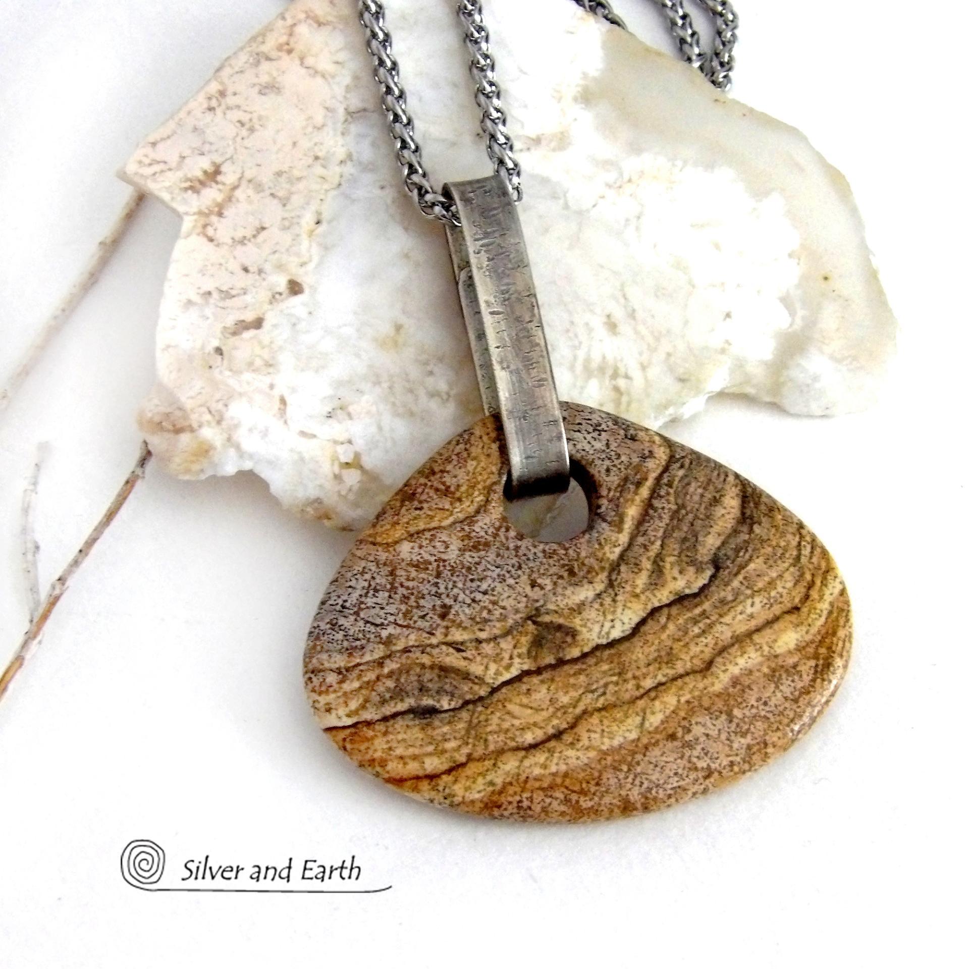 This handcrafted necklace features a large, chunky natural picture jasper stone accented with a handcrafted sterling silver bail. The stone has a beautiful natural pattern in various shades of brown, beige and gray. Big and bold, this necklace is a real one-of-a-kind statement piece - perfect for anyone that loves natural stones! It's reversible and can be worn on either side. Coordinating earrings sold separately. Handmade in the USA by Silver and Earth Jewelry.