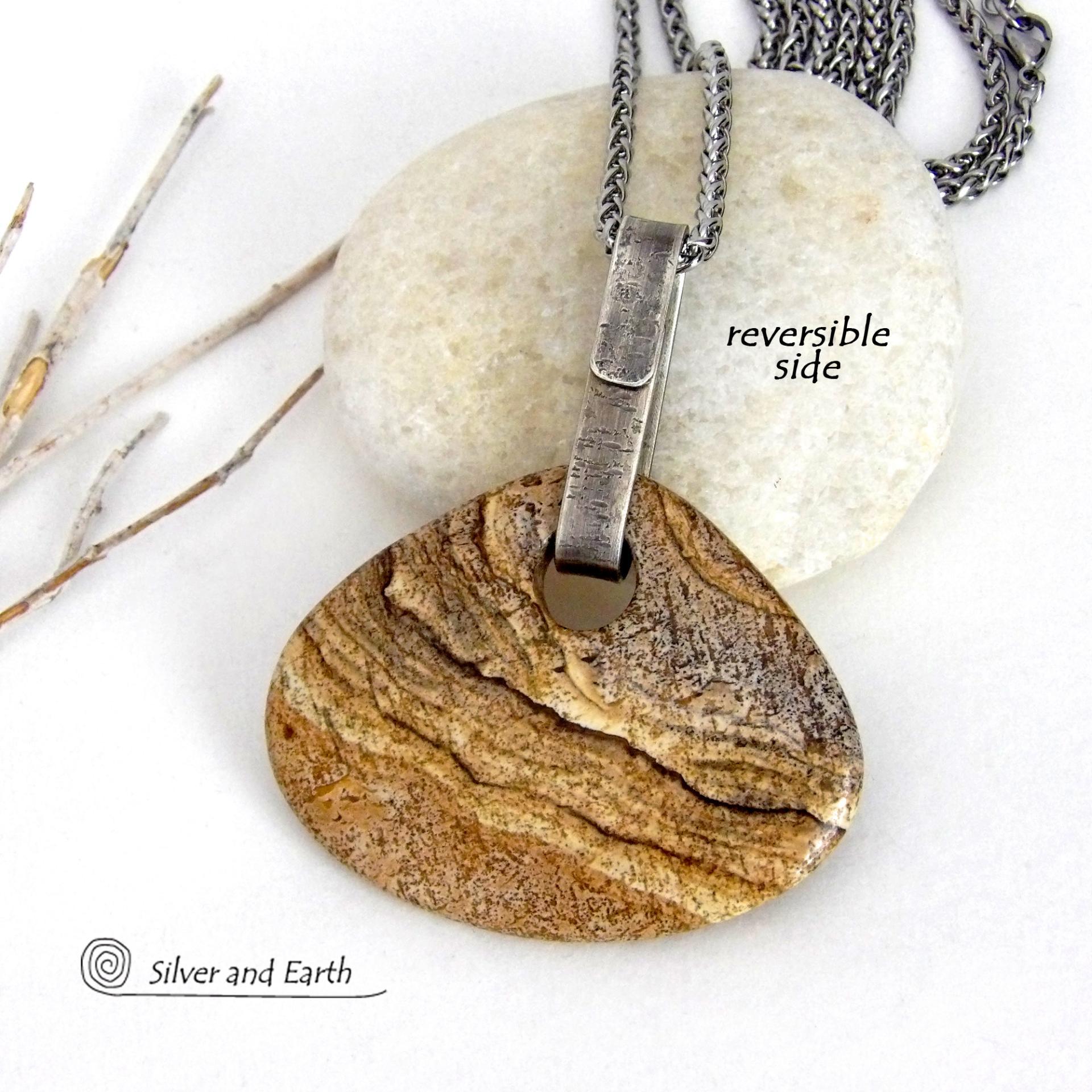 This handcrafted necklace features a large, chunky natural picture jasper stone accented with a handcrafted sterling silver bail. The stone has a beautiful natural pattern in various shades of brown, beige and gray. Big and bold, this necklace is a real one-of-a-kind statement piece - perfect for anyone that loves natural stones! It's reversible and can be worn on either side. Coordinating earrings sold separately. Handmade in the USA by Silver and Earth Jewelry.