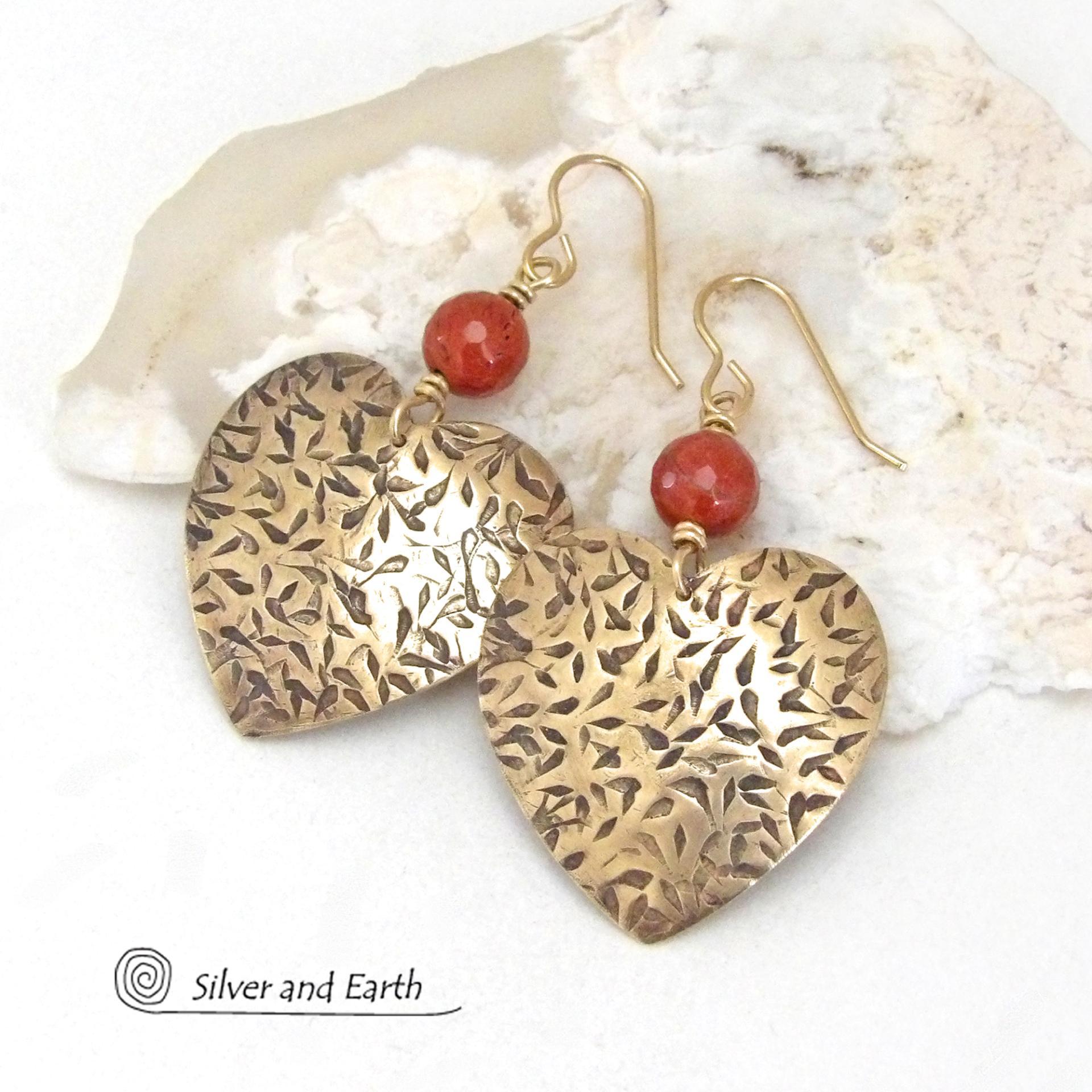 These handcrafted gold brass heart earrings have a hand stamped texture and are accented with faceted red jasper gemstones. They have a classic, modern style that coordinates beautifully with all wardrobe types. Full of romantic charm, they'll make a great gift for someone special on Mother's Day, Valentines' Day, a birthday, wedding anniversary -- or any day! 