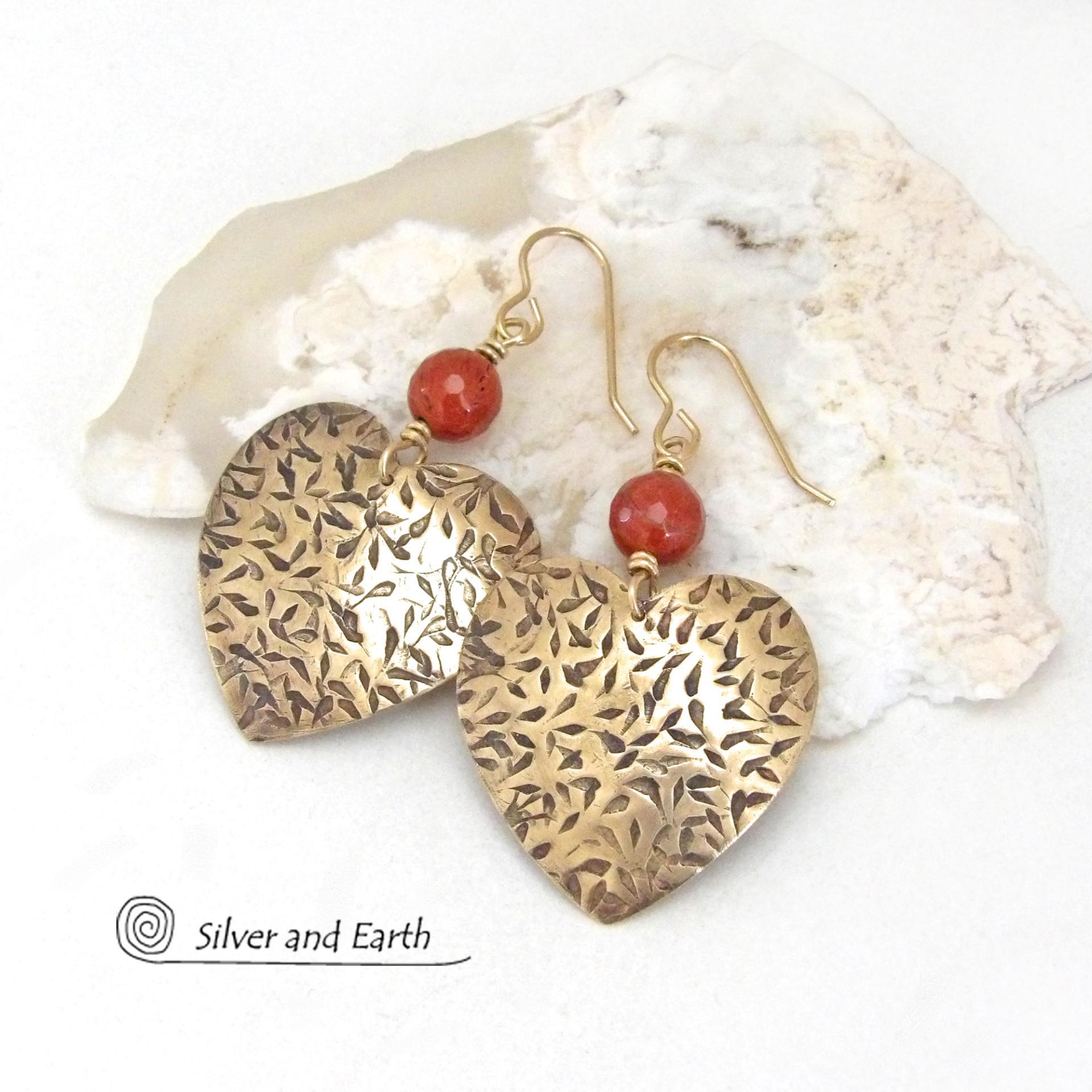 These handcrafted gold brass heart earrings have a hand stamped texture and are accented with faceted red jasper gemstones. They have a classic, modern style that coordinates beautifully with all wardrobe types. Full of romantic charm, they'll make a great gift for someone special on Mother's Day, Valentines' Day, a birthday, wedding anniversary -- or any day! 