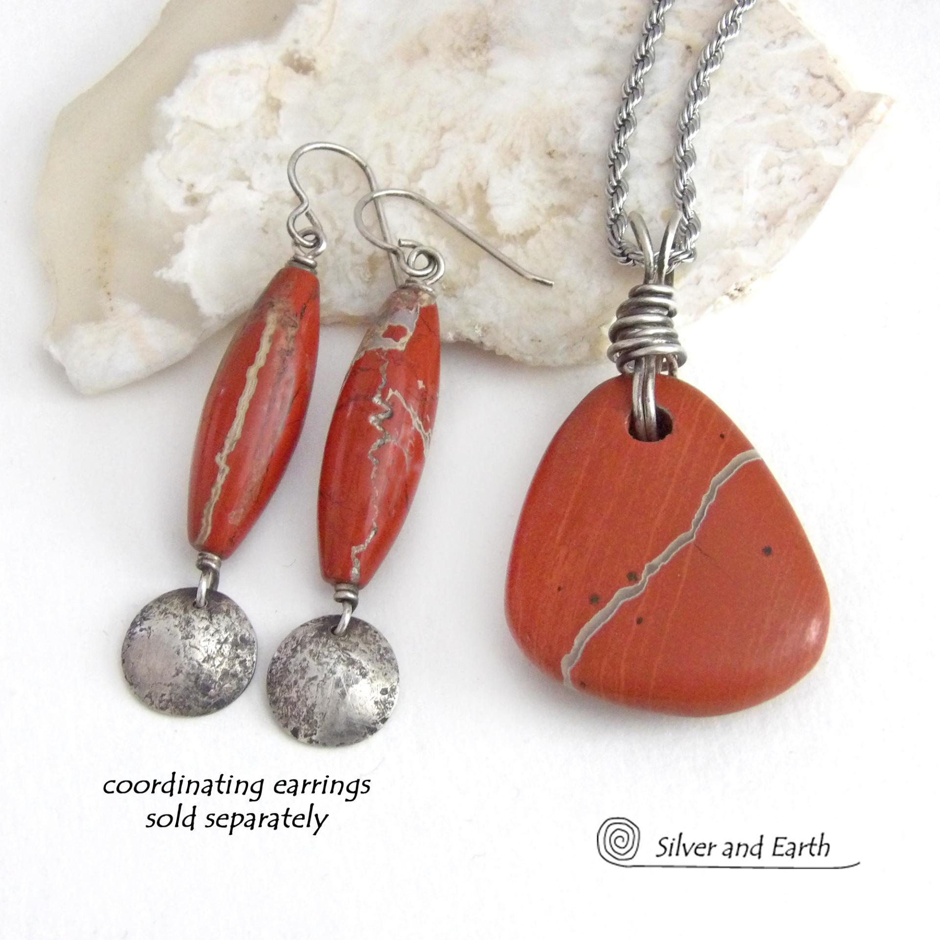 Simple and earthy - this pendant necklace features a natural red jasper gemstone with a wire wrapped sterling silver bail. The stone has a brick red hue with a natural matrix of beige streaks and dots. It has a modern minimalist appeal and is perfect for those that prefer simple, earthy jewelry. It has coordinating earrings which are sold separately. It makes a great gift for a natural stone lover - or a nice addition to your own jewelry wardrobe. Handmade in the USA by Silver and Earth Jewelry. 