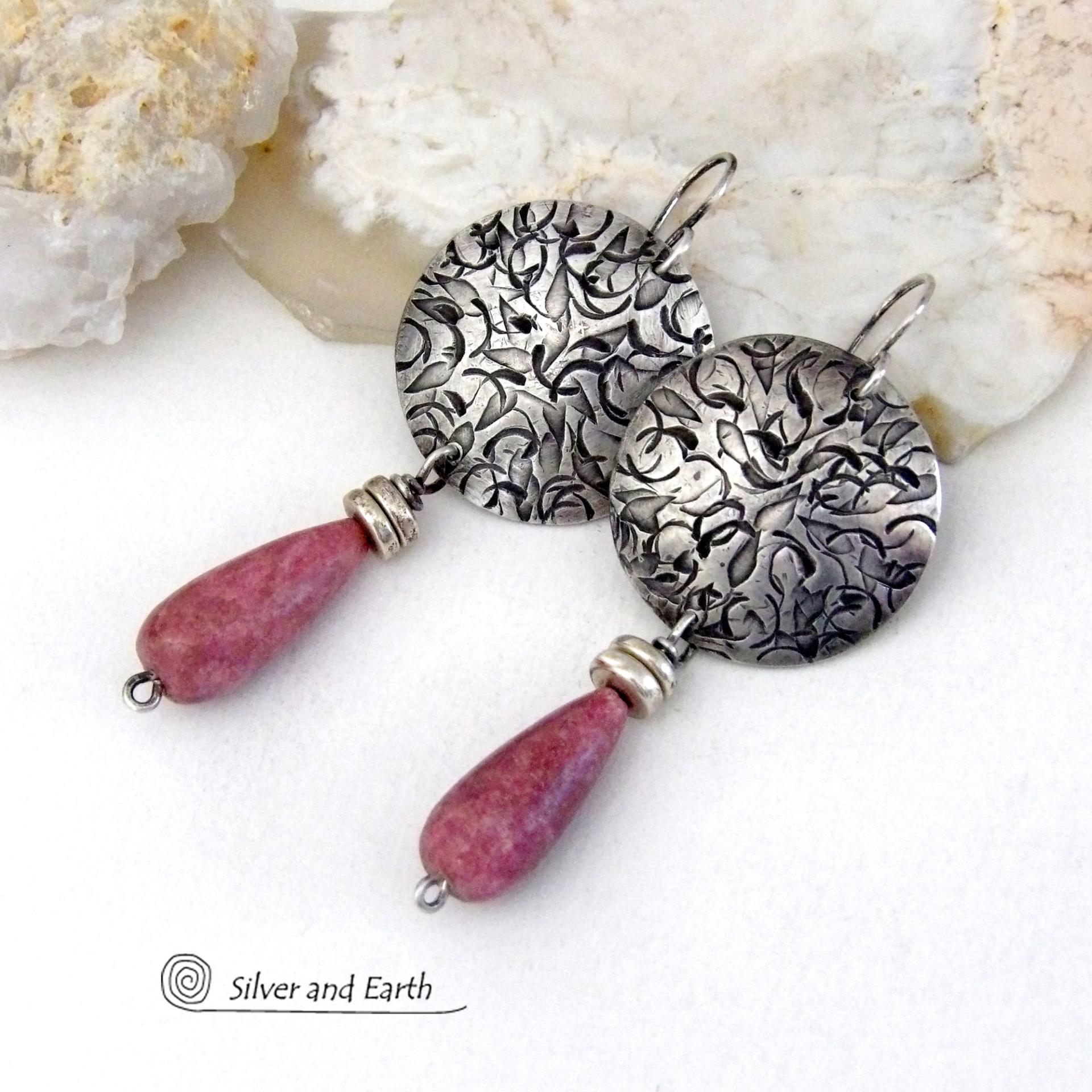 These handmade sterling silver earrings have a modern, classic design that will always be in fashion. They feature natural rhodonite gemstones dangling from textured sterling silver. The stones have a slender teardrop shape and a dark rosy pink hue with subtle brown inclusions. They are accented with tiny pewter beads. Perfect for all occasions -- they'll look great dressed up or down.
