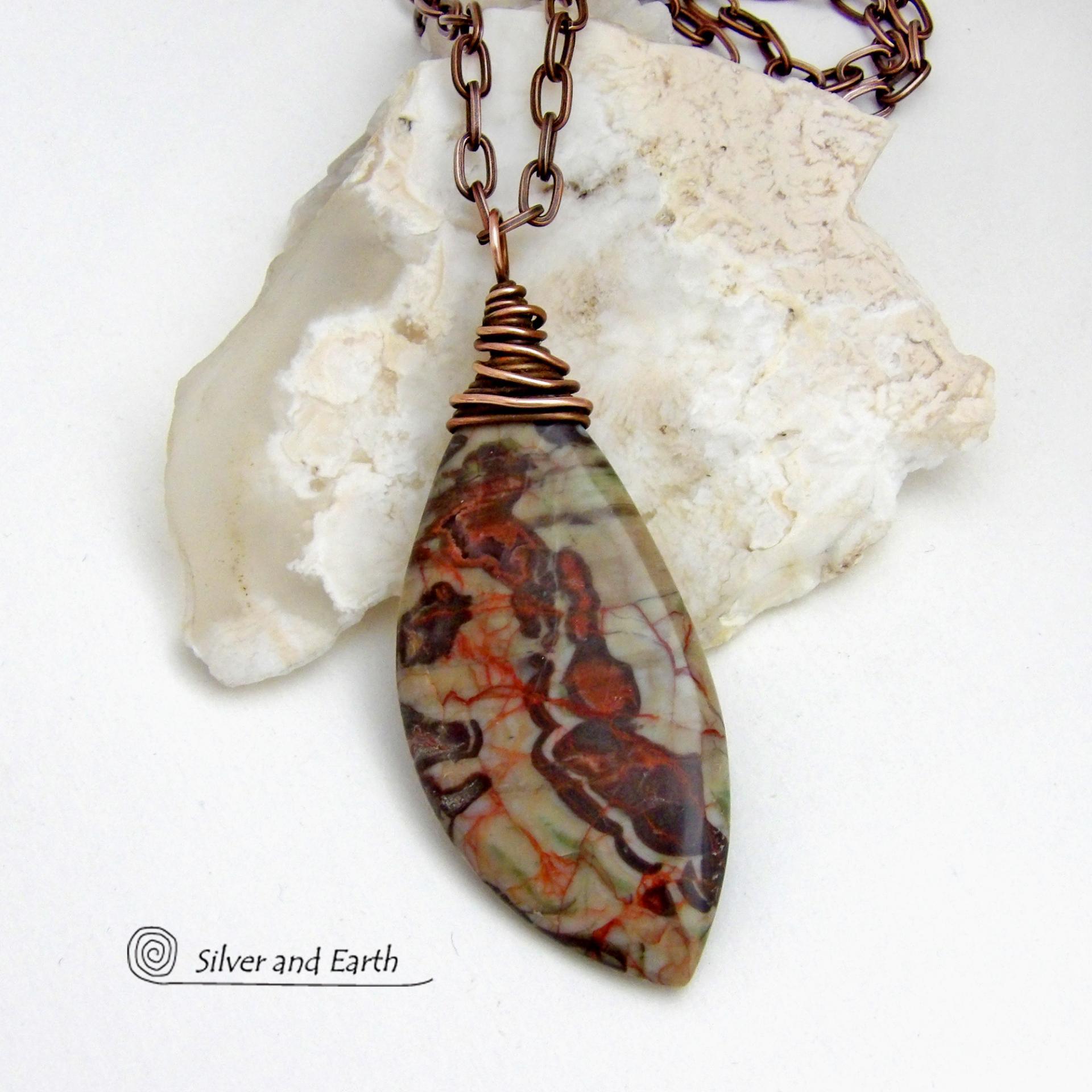 This necklace features a natural rhyolite jasper stone with a natural pattern in earthy hues of rusty orange, brown and taupe. It is wrapped in oxidized copper wire and comes on an 18" copper chain necklace. It has an earthy, natural style and will make a great gift for a natural stone lover - or a nice addition to your own jewelry collection. The chain can be removed from the pendant and worn with other pendants in your wardrobe. Coordinating earrings sold separately. 