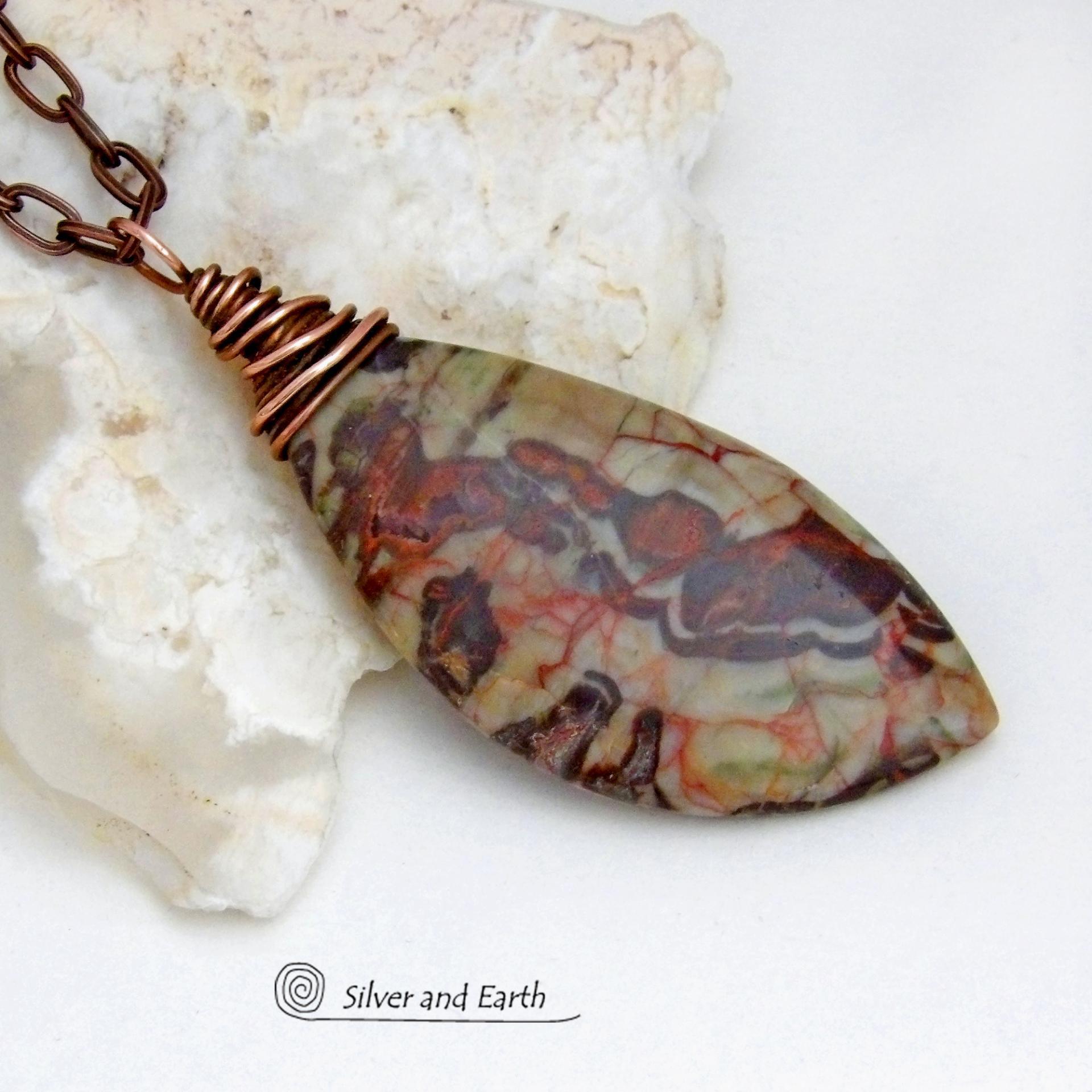 This necklace features a natural rhyolite jasper stone with a natural pattern in earthy hues of rusty orange, brown and taupe. It is wrapped in oxidized copper wire and comes on an 18" copper chain necklace. It has an earthy, natural style and will make a great gift for a natural stone lover - or a nice addition to your own jewelry collection. The chain can be removed from the pendant and worn with other pendants in your wardrobe. Coordinating earrings sold separately. 