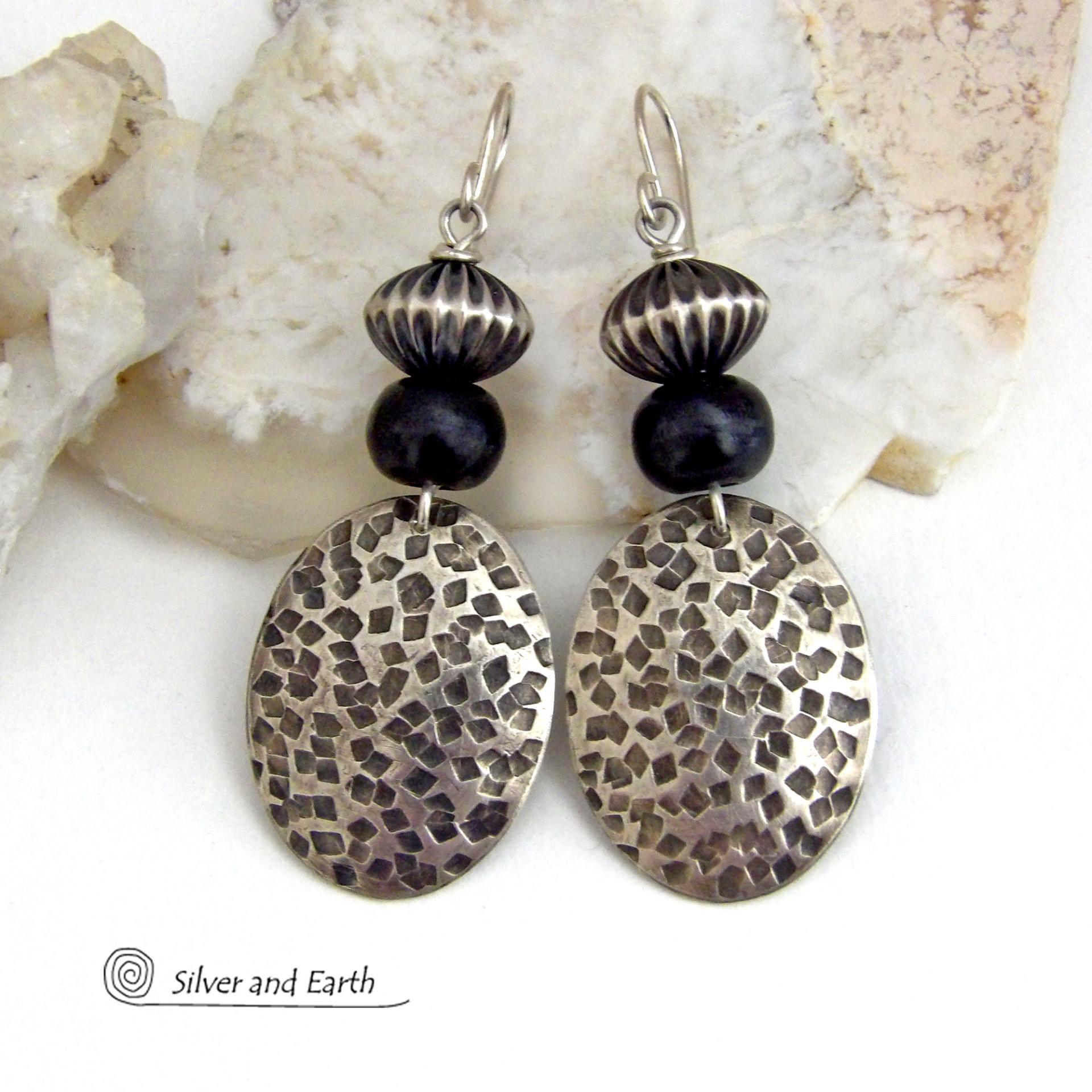 These sterling silver earrings have an earthy, southwestern tribal style. They feature hand textured sterling silver dangles accented with black buffalo horn and Native Navajo pearl style sterling silver beads with a rich, corrugated texture. Unique and striking, they'll make a bold statement. Handmade in the USA by Silver and Earth Jewelry. 