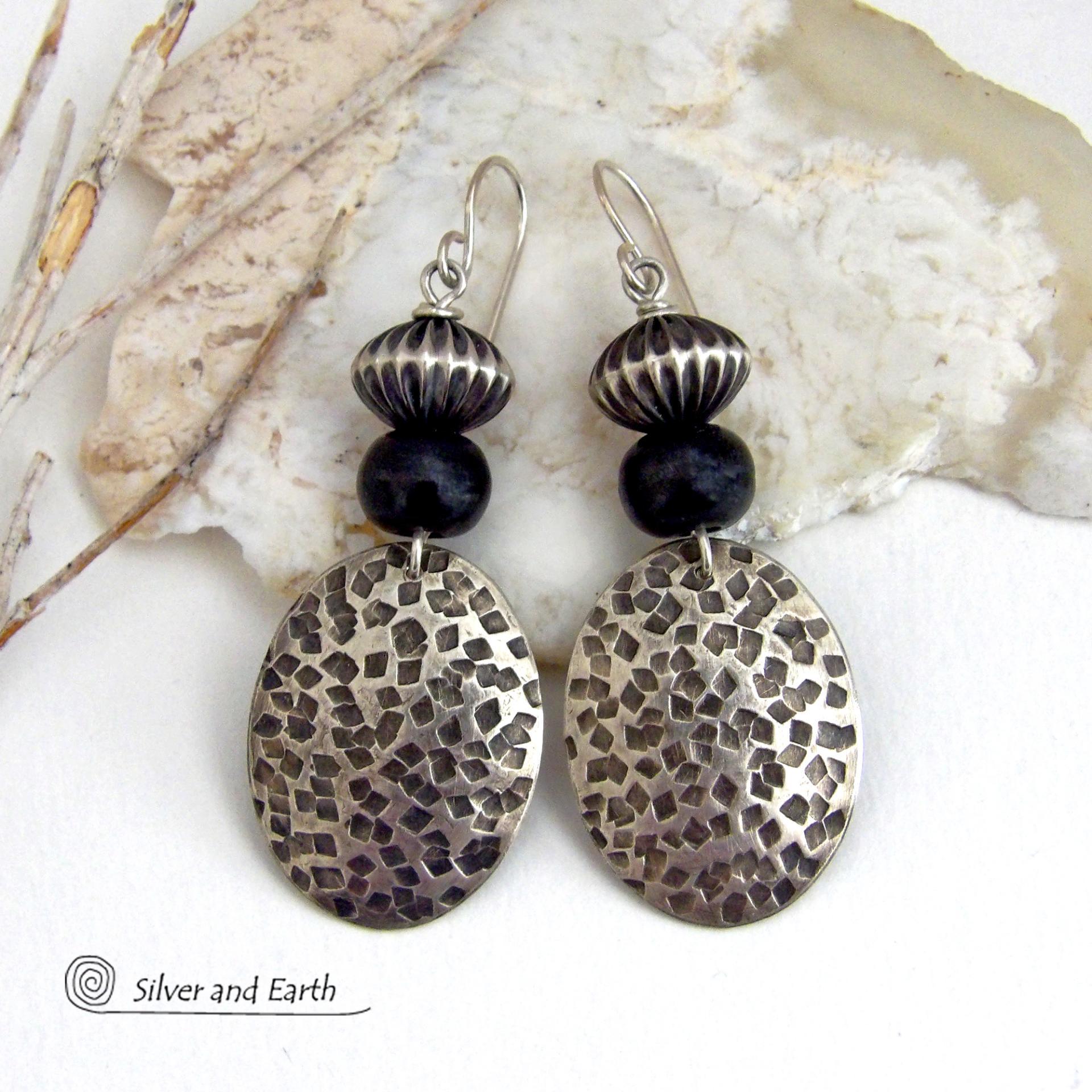 These sterling silver earrings have an earthy, southwestern tribal style. They feature hand textured sterling silver dangles accented with black buffalo horn and Native Navajo pearl style sterling silver beads with a rich, corrugated texture. Unique and striking, they'll make a bold statement. Handmade in the USA by Silver and Earth Jewelry. 