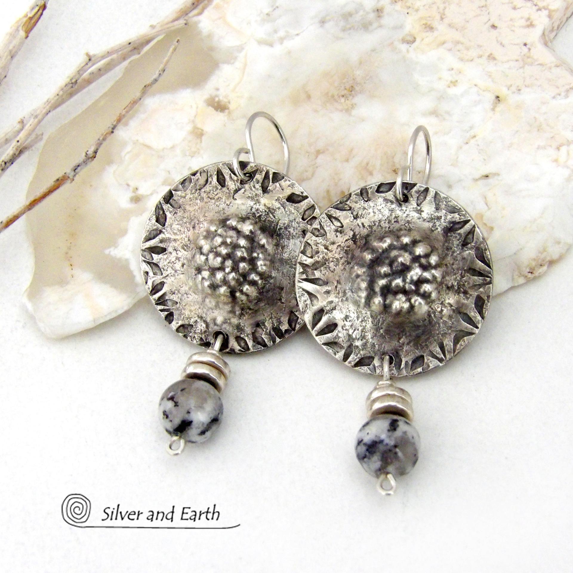 These handcrafted sterling silver earrings have a hammered and hand stamped texture and are accented with granite agate gemstones and silver pewter beads. The stones have a natural speckled matrix of black, white and gray that resembles granite. They have a bold chic, contemporary modern style that makes a unique statement.