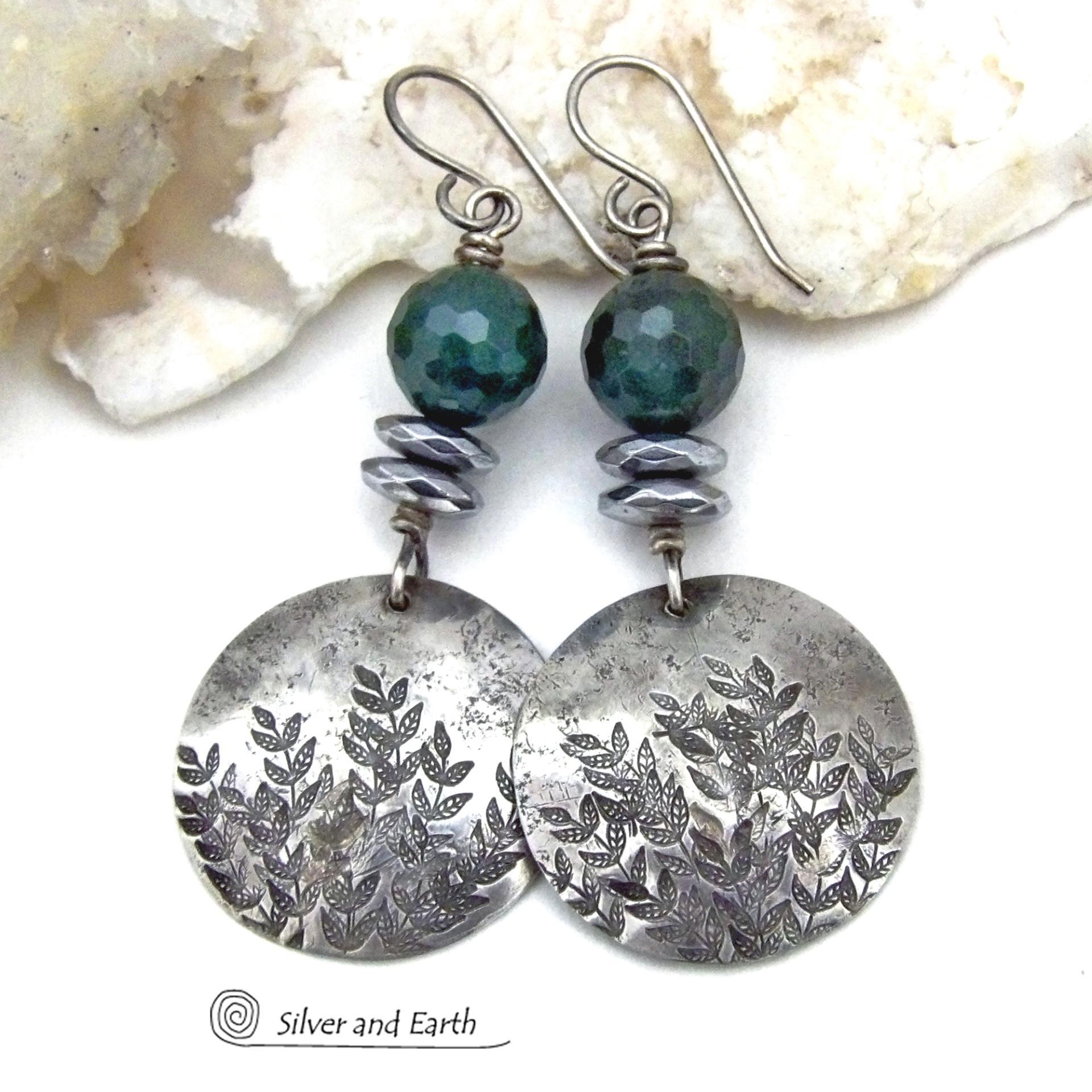 These handcrafted sterling silver earrings feature a hand stamped leaf design and are accented with dark green moss agate gemstones. The stones have a micro-faceted finish which gives off a natural sparkle and shine and are accented them with faceted silver hematite gemstones which also give off a natural sparkle. These earrings have a modern chic and elegant style that coordinates beautifully with all wardrobe types - dressed up or down. Handmade in the USA by Silver and Earth Jewelry. 