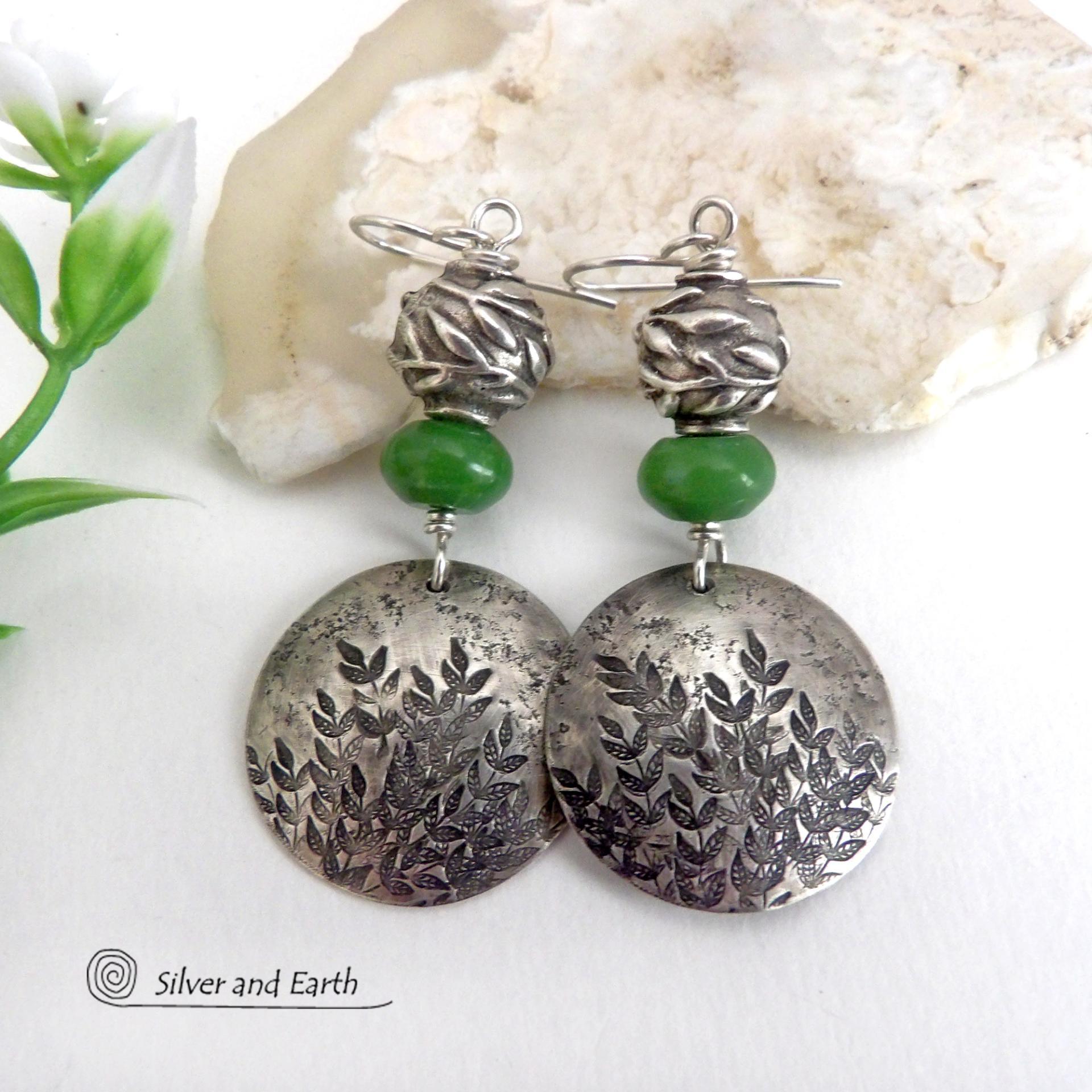 These handcrafted sterling silver earrings feature a hand stamped leaf design and are accented with green serpentine gemstones and pewter beads. The beads have a beautifully detailed 3-dimensional carved pattern of vines and leaves. They have a modern, earthy and elegant style that coordinates beautifully with all wardrobe types. They'll make a great gift for a nature lover - or a nice addition to your own jewelry wardrobe.