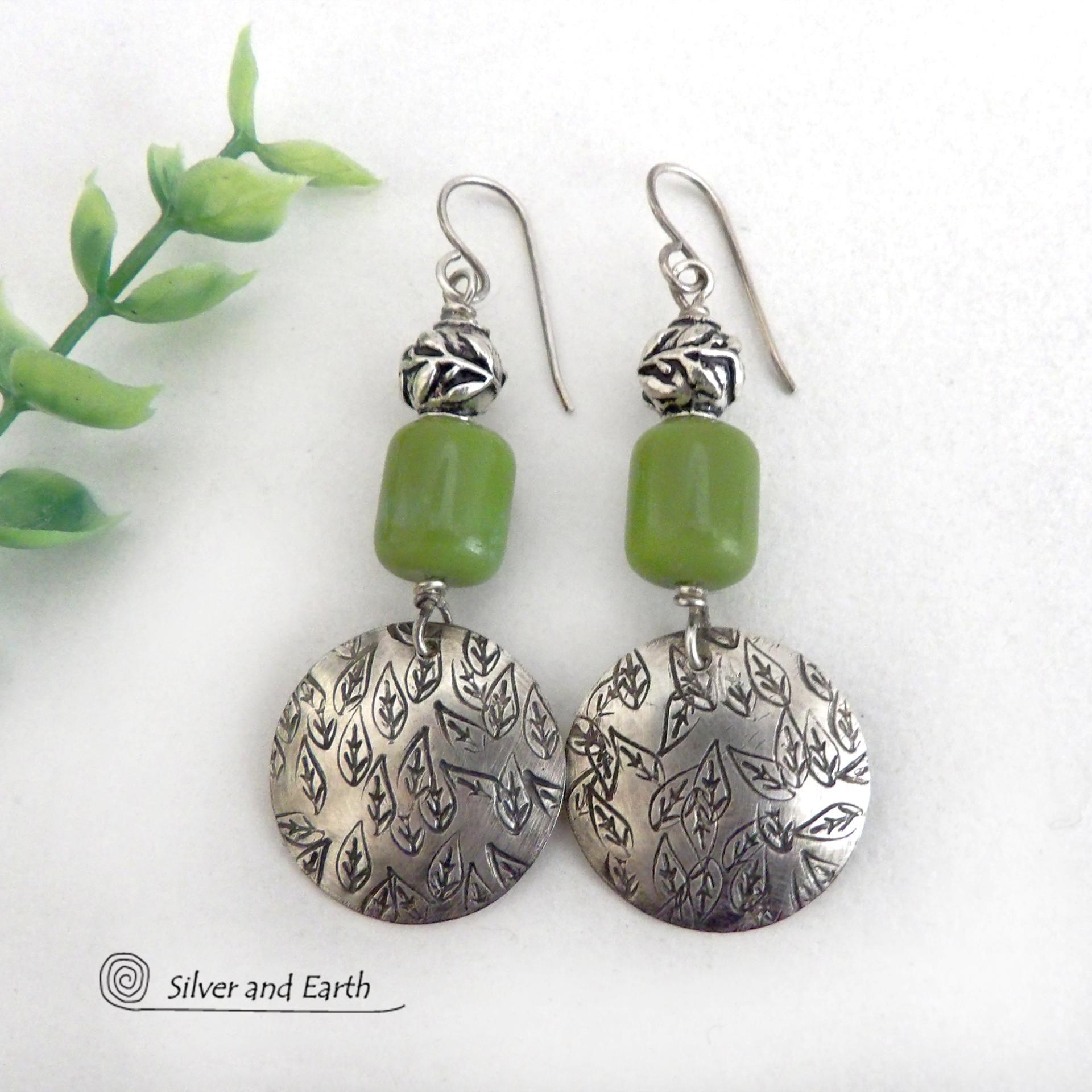 Sterling silver earrings with a hand stamped leaf design accented with natural green serpentine stones and silver pewter beads. The stones have a lime green hue and the pewter beads have a beautifully detailed 3-dimensional carved pattern of vines and leaves. They have a modern, earthy style and will make a great gift for a nature lover.  These artisan-made earrings are perfect for adding a touch of earthy modern style to any outfit. 