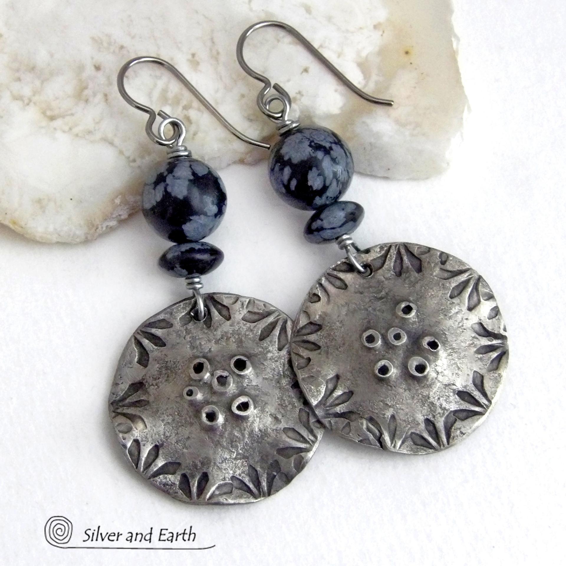 These handcrafted earrings have a modern bold edgy vibe. They feature rustic hammered and hand stamped silver tone pewter dangles accented with natural snowflake obsidian gemstones. The stones have a natural pattern in hues of black and soft gray. This stone is a natural volcanic glass which contains the mineral cristobalite - which creates the "snowflake" type patterns. Bold and striking - they're sure to make a statement. Perfect for women that love natural stones and unique artisan handmade jewelry. 