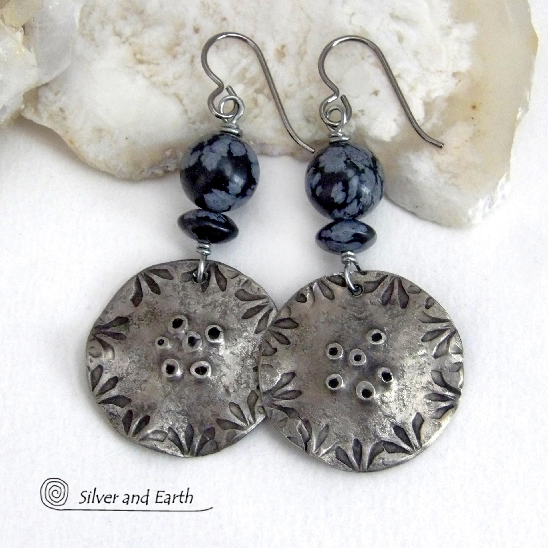 These handcrafted earrings have a modern bold edgy vibe. They feature rustic hammered and hand stamped silver tone pewter dangles accented with natural snowflake obsidian gemstones. The stones have a natural pattern in hues of black and soft gray. This stone is a natural volcanic glass which contains the mineral cristobalite - which creates the "snowflake" type patterns. Bold and striking - they're sure to make a statement. Perfect for women that love natural stones and unique artisan handmade jewelry. 