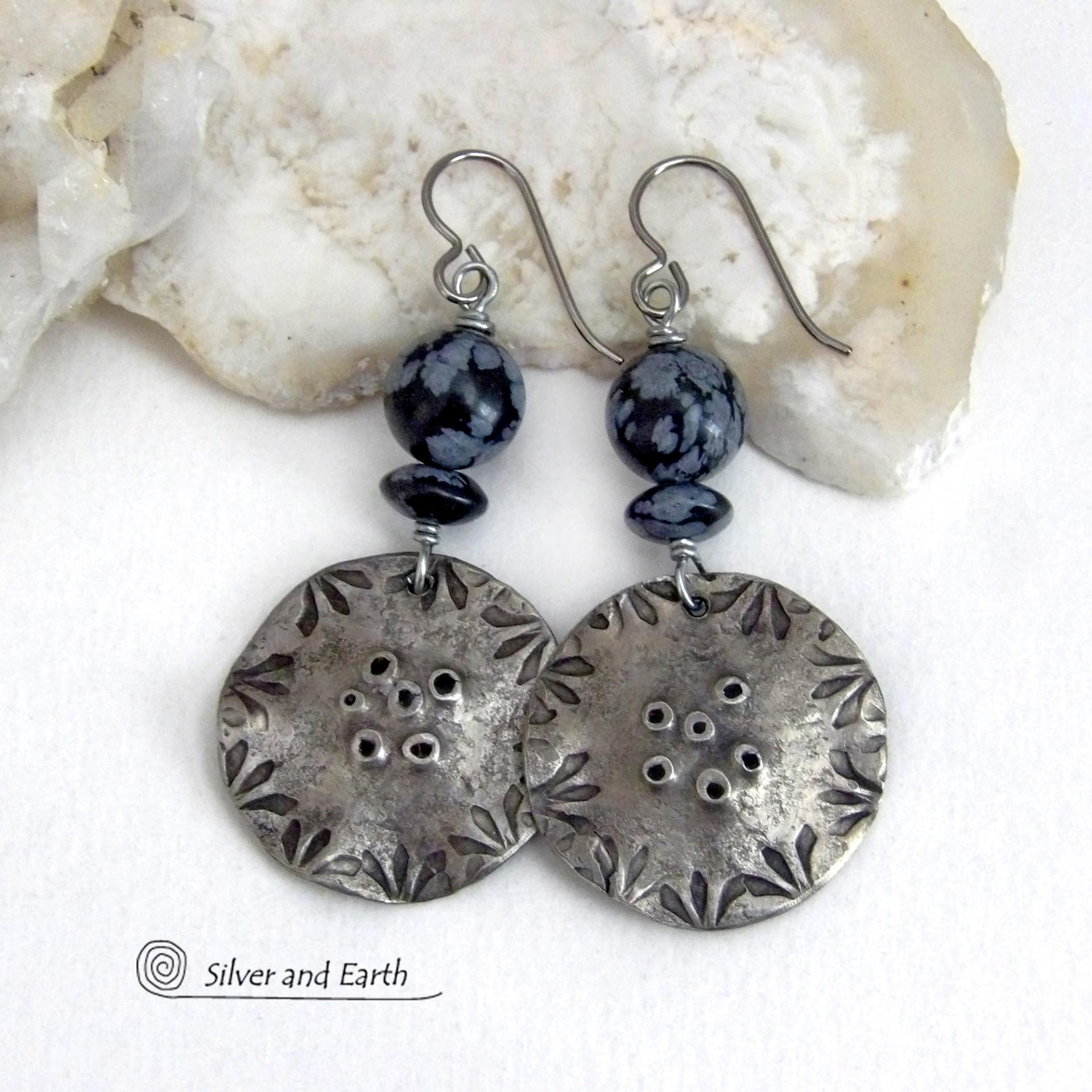 These handcrafted earrings have a modern bold edgy vibe. They feature rustic hammered and hand stamped silver tone pewter dangles accented with natural snowflake obsidian gemstones. The stones have a natural pattern in hues of black and soft gray. This stone is a natural volcanic glass which contains the mineral cristobalite - which creates the "snowflake" type patterns. Bold and striking - they're sure to make a statement. Perfect for women that love natural stones and unique artisan handmade jewelry. 