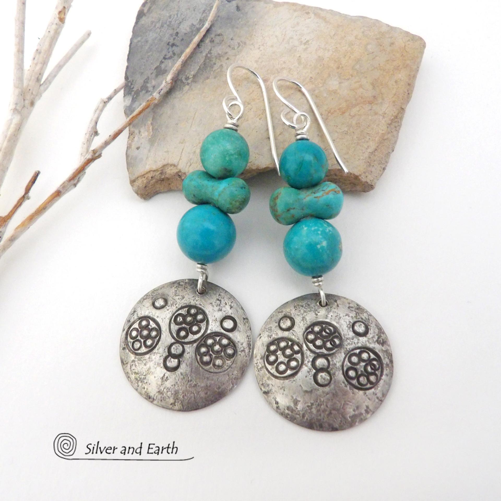 These handcrafted earrings feature sterling silver dangles with a hand stamped texture accented with a stack of round and uniquely "bow shaped" genuine natural turquoise stones. Bold and striking, they have an earthy modern rustic vibe with southwest style and flair that will look great with all types of outfits.  These earrings are perfect for women that love natural stones and unique, one-of-a-kind statement jewelry.