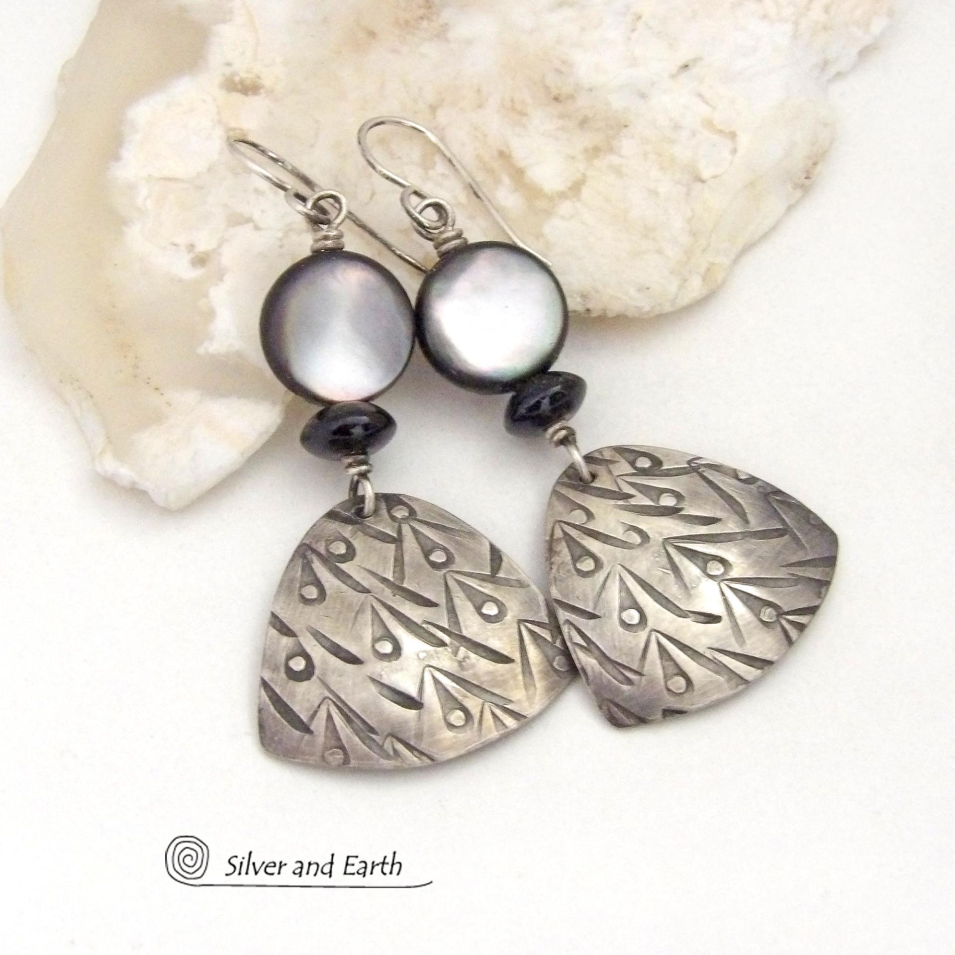 These handcrafted sterling silver earrings have a hand stamped texture and feature round black lip Mother-of-Pearl beads and tiny black onyx stones. The Mother of Pearl has a natural shimmery white hue with "rims" of black. They have a modern elegant chic style that will look great dressed up or down.