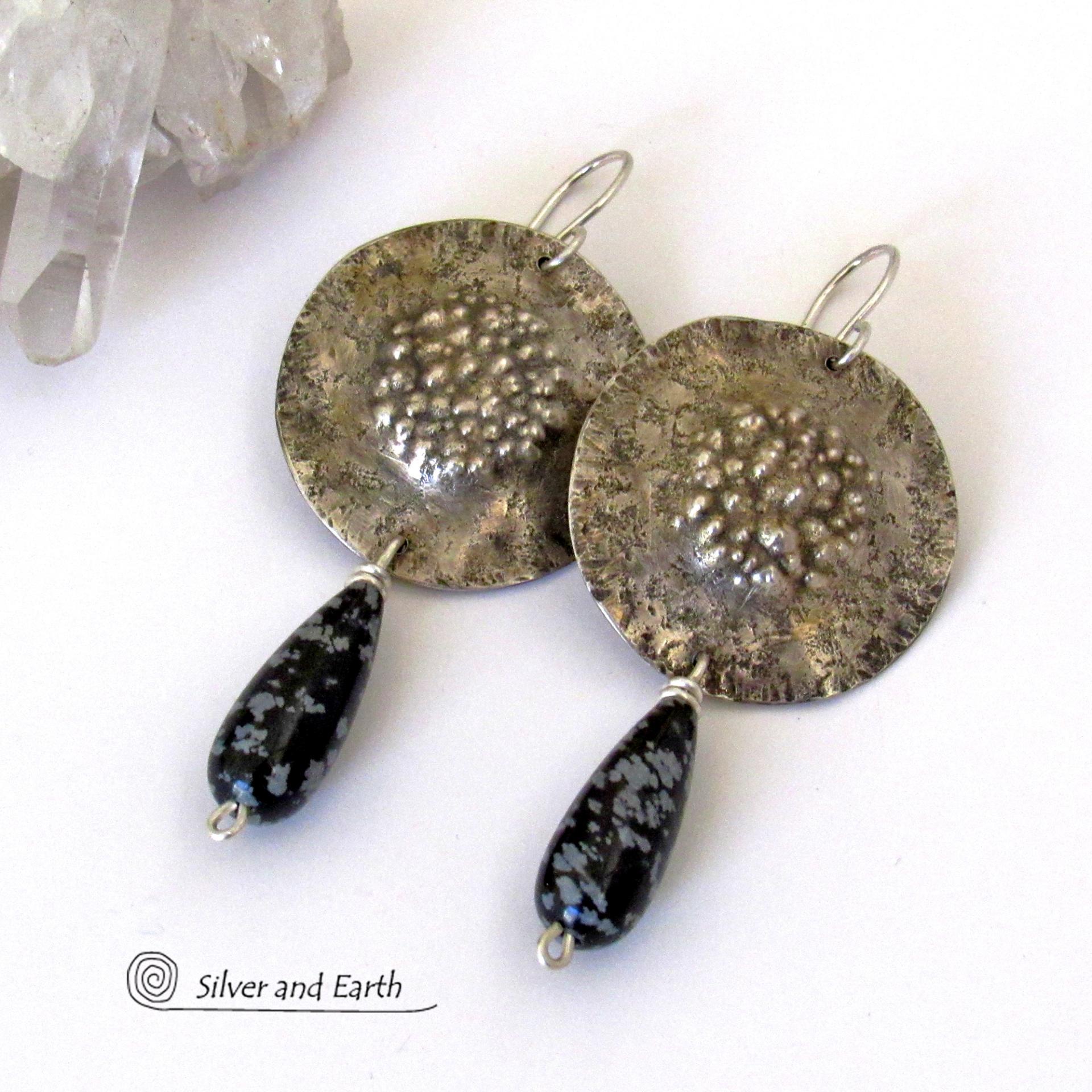 These handcrafted sterling silver earrings have a bold, organic and edgy vibe. They feature snowflake obsidian gemstones dangling from textured sterling silver. The stones have a natural pattern in hues of black and soft gray. This stone is a natural volcanic glass which contains the mineral cristobalite - which creates the "snowflake" type patterns.