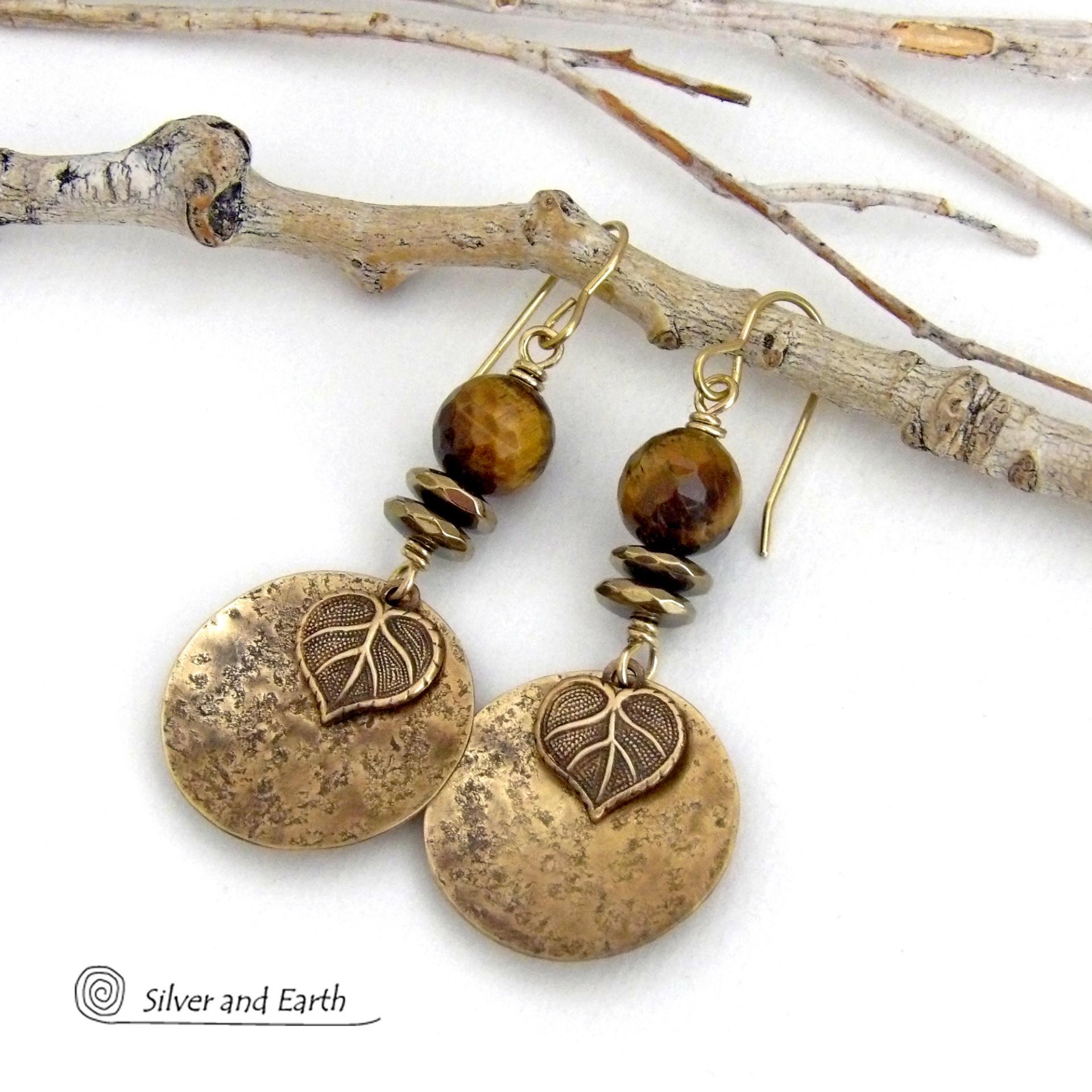 These handcrafted earrings feature gold brass dangles with a lightly hammered texture accented with natural tiger's eye gemstones, brass leaf charms and faceted hematite stones with a sparkly electroplated gold tone finish. The tiger's eye stones also have a faceted cut which casts off a beautiful natural sparkle and shine. They have a modern, elegant chic style that coordinates with all wardrobe styles. Makes a great gift for a nature lover - or a nice addition to your own jewelry wardrobe. 