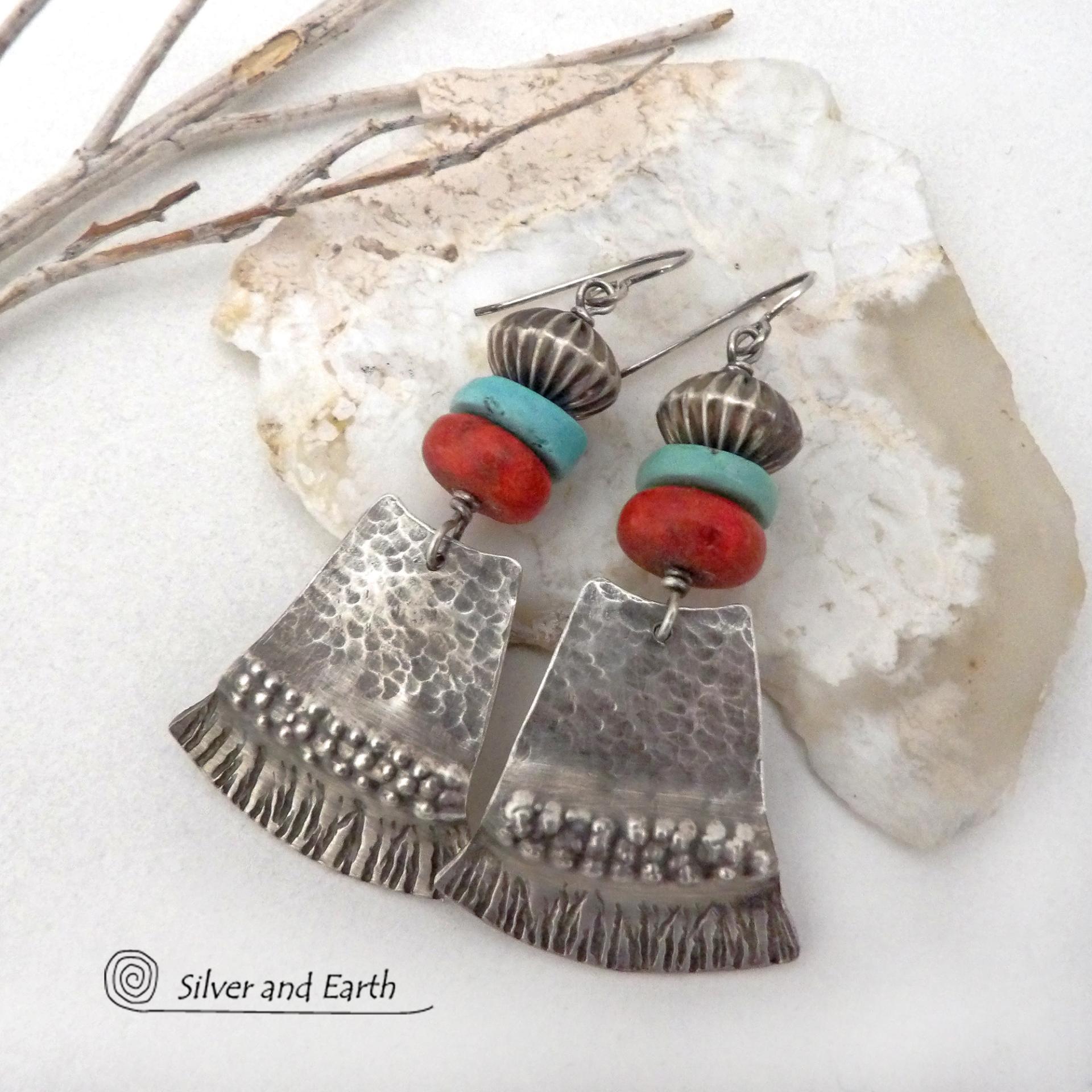 These handcrafted earrings feature hammered and hand stamped sterling silver dangles accented with a stack of natural turquoise stones, fossilized red coral and oxidized sterling silver Native style beads with a rich, corrugated texture. They have a modern, southwestern tribal flair that makes a bold statement. Perfect for women that love the Santa Fe southwest style.The earrings are handmade and are a beautiful example of southwest style jewelry. Handmade by Silver and Earth, a New Mexico True Certified b 