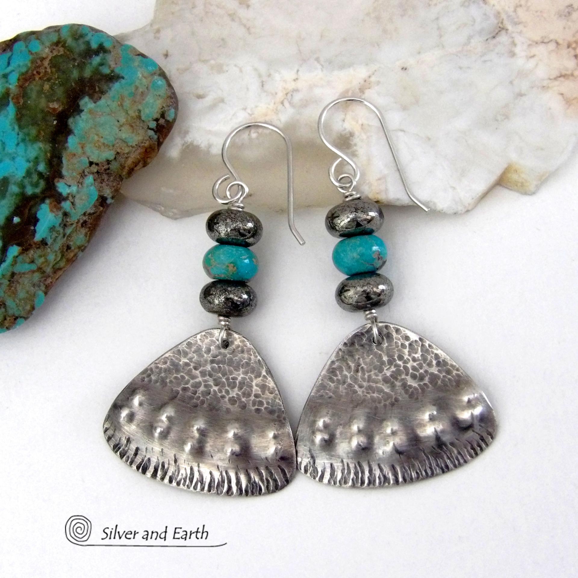 These handcrafted sterling silver earrings feature a unique hand textured design and are accented with natural turquoise and metallic gray pyrite stones. They have a southwestern boho tribal flair and will make a striking statement. The pyrite stones add a touch of natural sparkle and shine. Handmade in the USA by Silver and Earth Jewelry. 