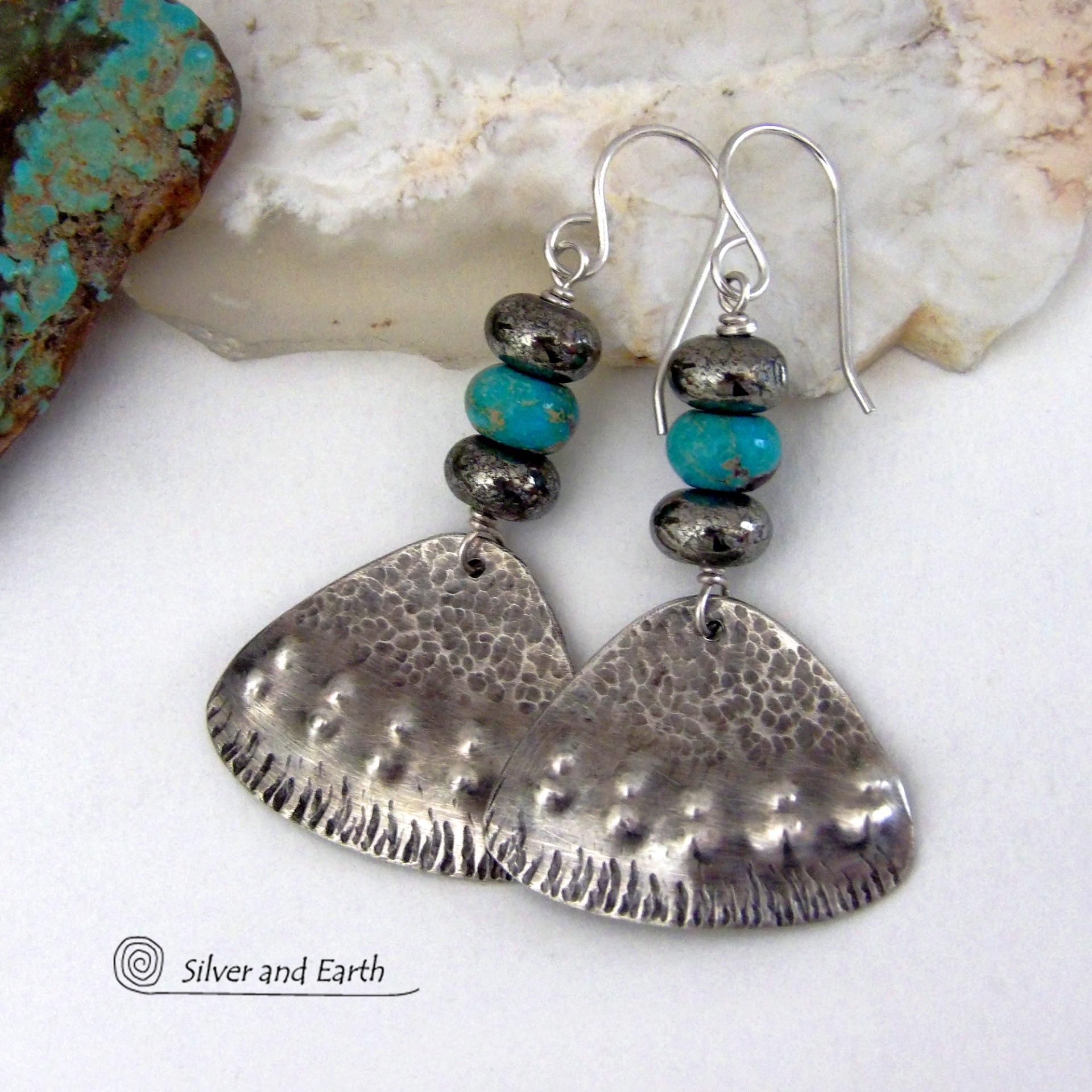 These handcrafted sterling silver earrings feature a unique hand textured design and are accented with natural turquoise and metallic gray pyrite stones. They have a southwestern boho tribal flair and will make a striking statement. The pyrite stones add a touch of natural sparkle and shine. Handmade in the USA by Silver and Earth Jewelry. 