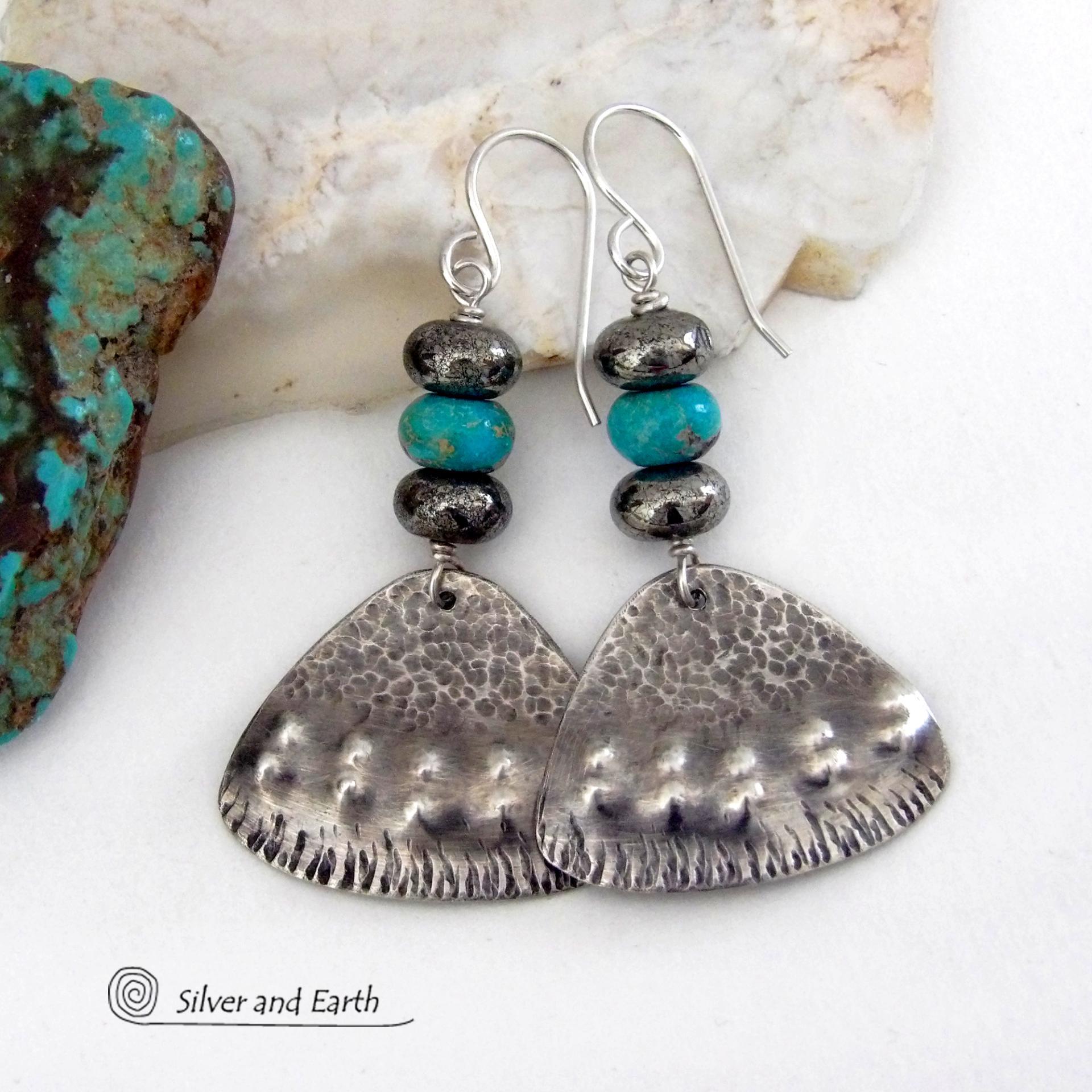 These handcrafted sterling silver earrings feature a unique hand textured design and are accented with natural turquoise and metallic gray pyrite stones. They have a southwestern boho tribal flair and will make a striking statement. The pyrite stones add a touch of natural sparkle and shine. Handmade in the USA by Silver and Earth Jewelry. 
