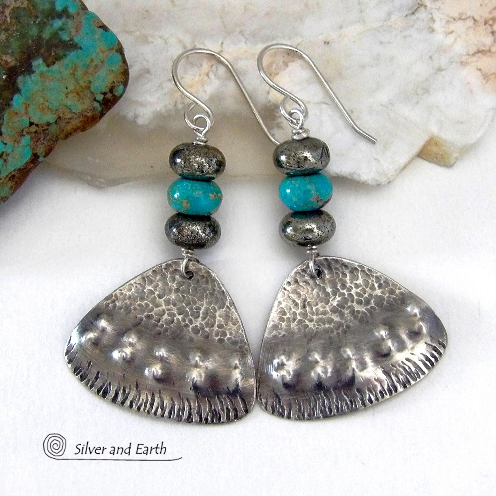 These handcrafted sterling silver earrings feature a unique hand textured design and are accented with natural turquoise and metallic gray pyrite stones. They have a southwestern boho tribal flair and will make a striking statement. The pyrite stones add a touch of natural sparkle and shine. Handmade in the USA by Silver and Earth Jewelry. 