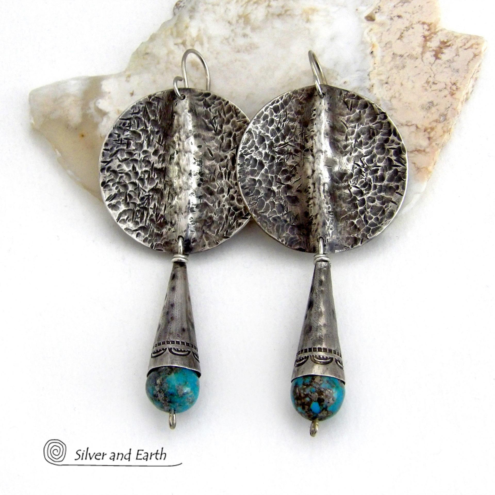 Big and bold - these handcrafted sterling silver earrings have an earthy, organic design with an edgy, modern southwest style. They feature solid sterling silver with a rustic, hammered texture and a dark oxidized finish. They are accented with hammered and hand stamped sterling silver cones and natural turquoise stone beads. Perfect for women that love to wear bold organic looking jewelry with a subtle southwest style and flair. Handmade in USA by Silver and Earth, a New Mexico True Certified Business.