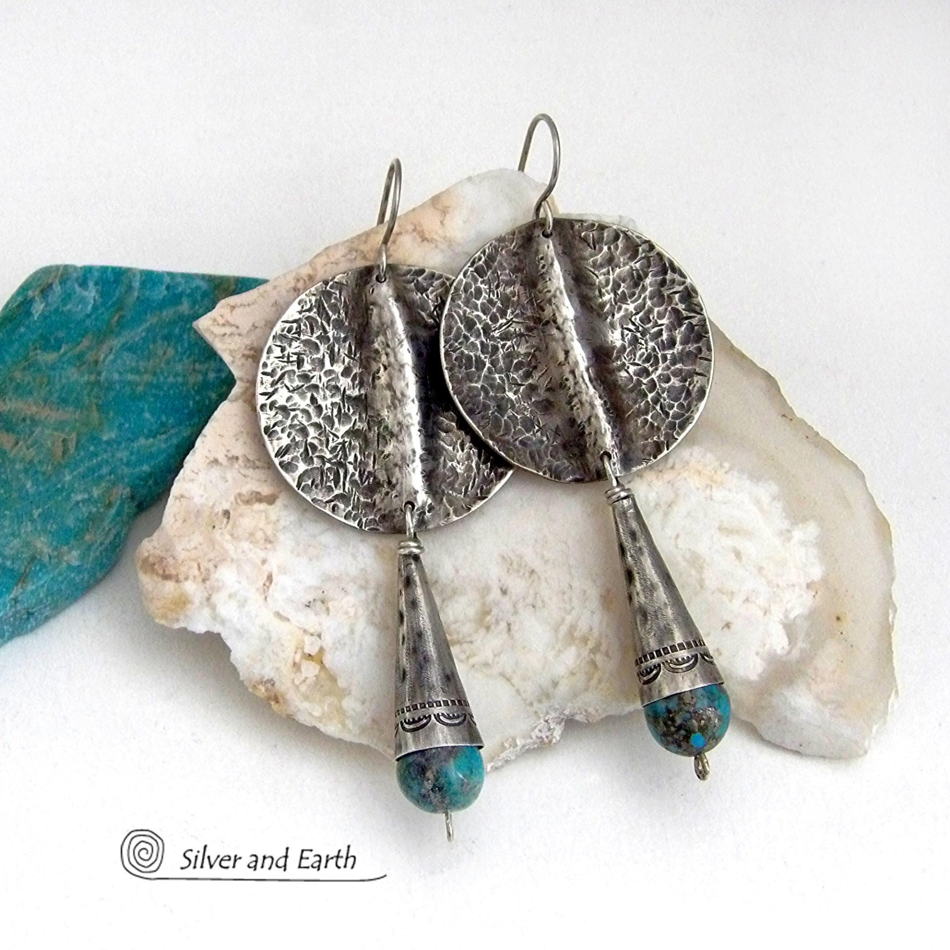 Big and bold - these handcrafted sterling silver earrings have an earthy, organic design with an edgy, modern southwest style. They feature solid sterling silver with a rustic, hammered texture and a dark oxidized finish. They are accented with hammered and hand stamped sterling silver cones and natural turquoise stone beads. Perfect for women that love to wear bold organic looking jewelry with a subtle southwest style and flair. Handmade in USA by Silver and Earth, a New Mexico True Certified Business.
