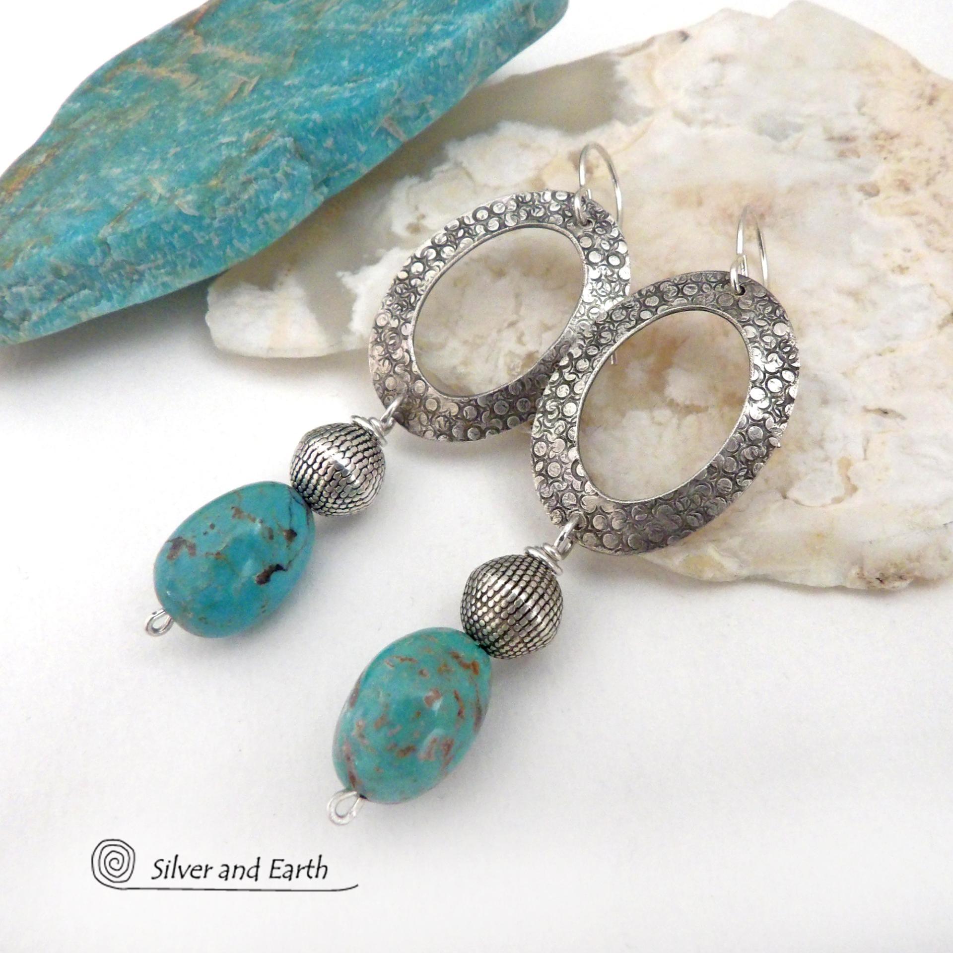 These handcrafted earrings feature hand stamped sterling silver oval hoops accented with natural turquoise stone nuggets and textured silver plated beads. They have a chic modern style with touch of southwestern flair that will coordinate beautifully with all wardrobe types. 